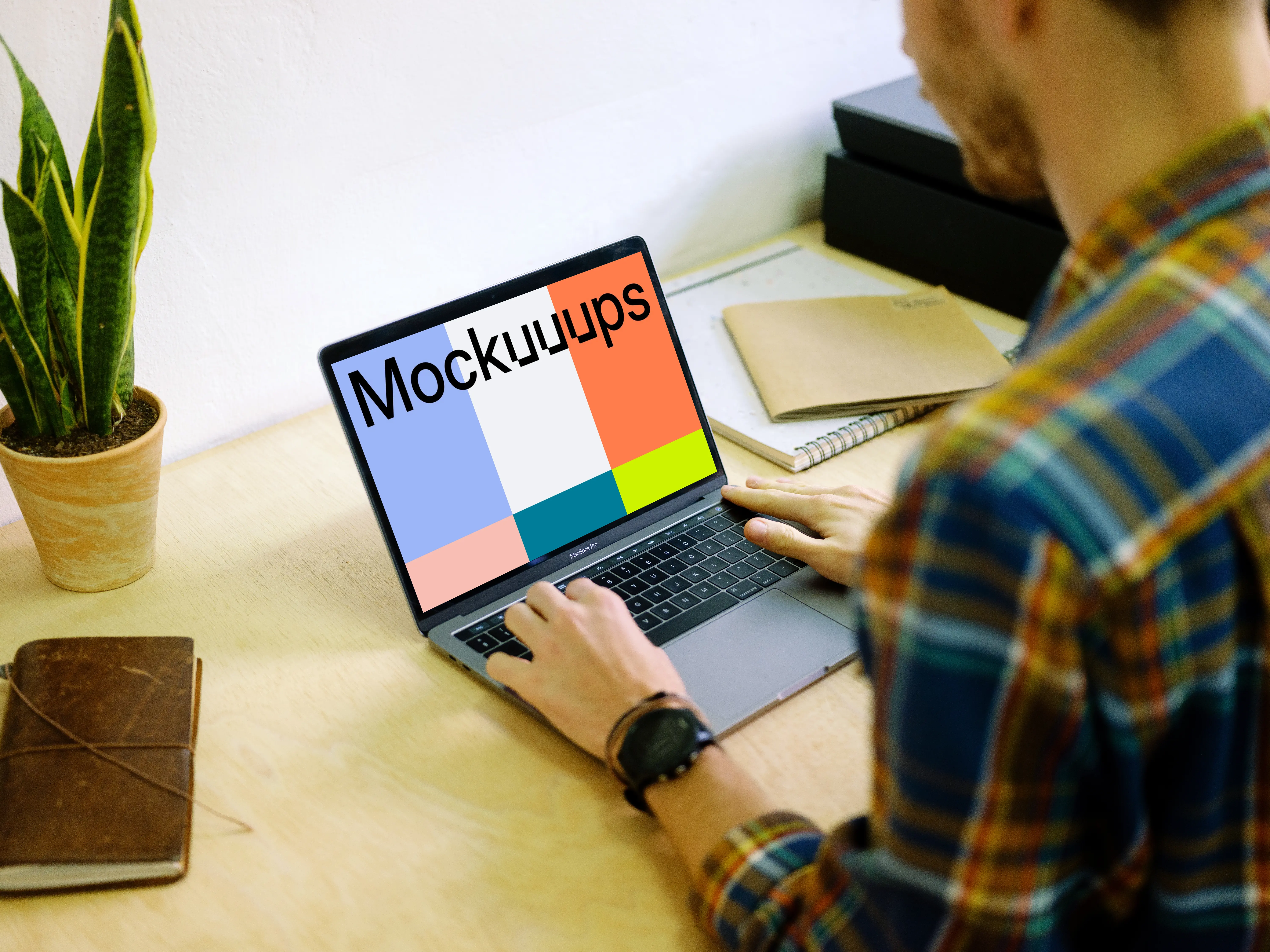 Typing on Macbook Pro mockup on desk