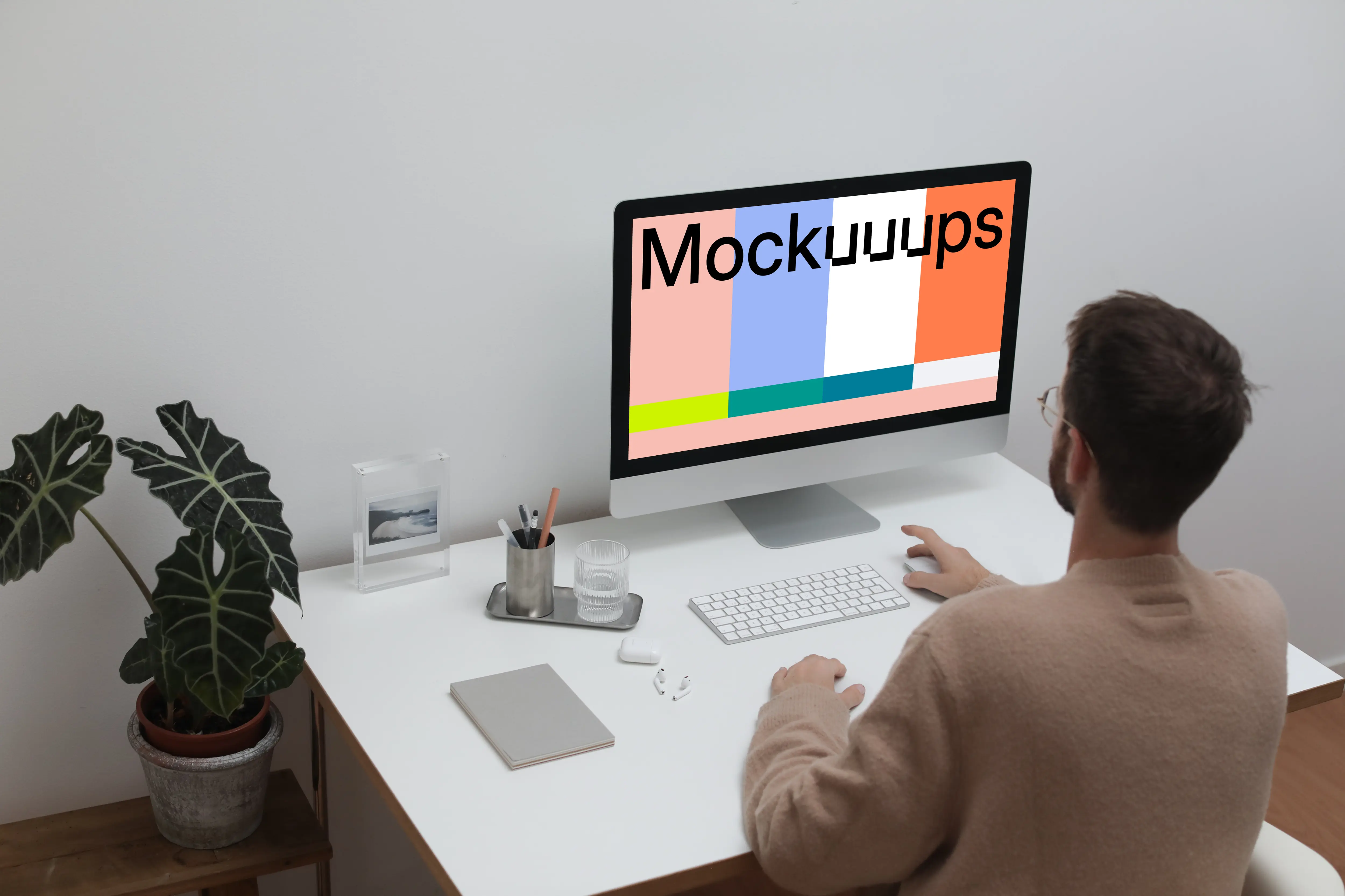 User using an iMac at his workstation