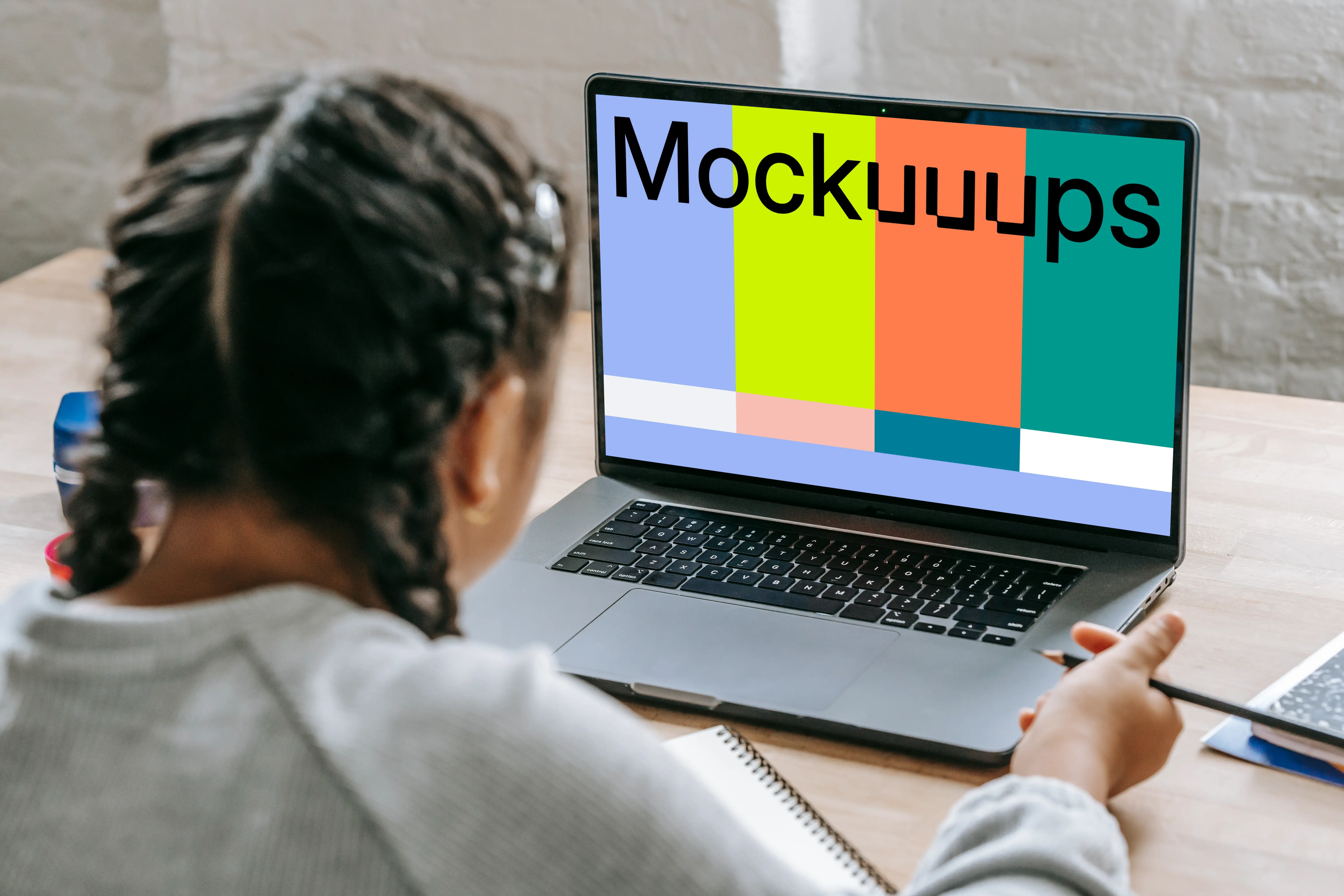 Young girl studying with a MacBook Pro mockup