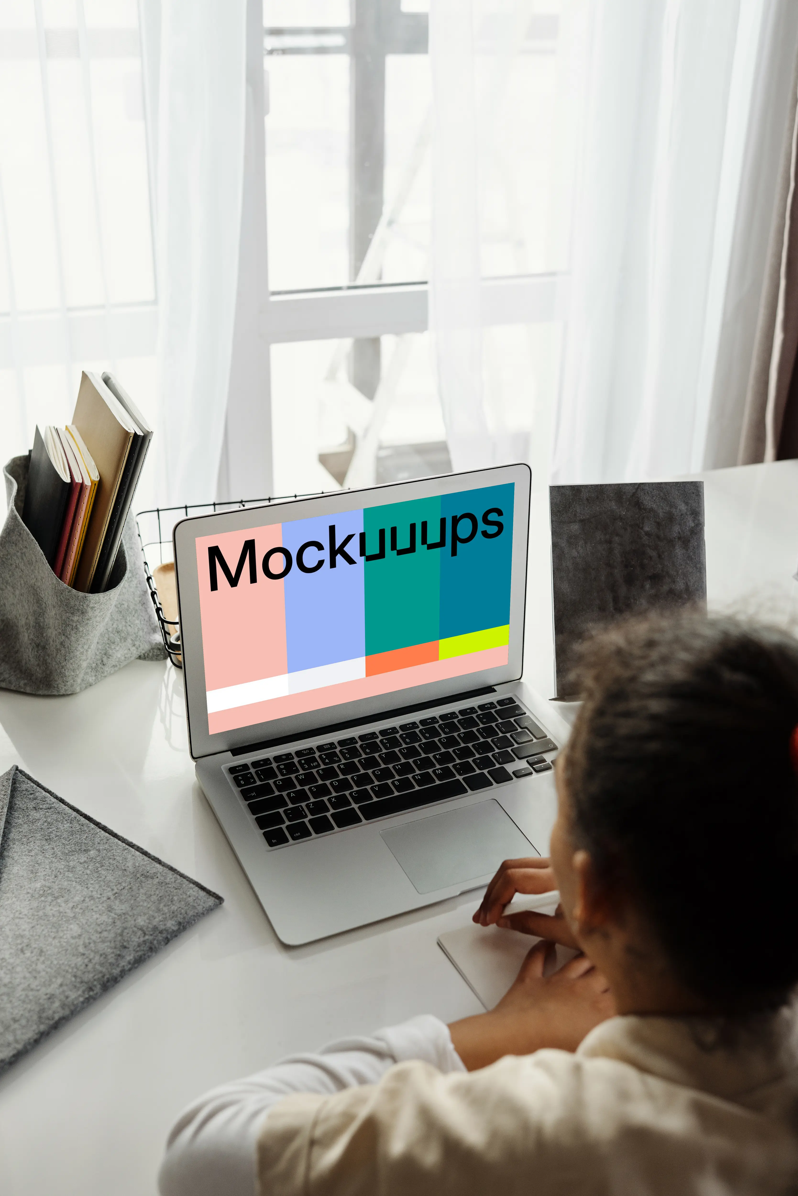 Young girl working on her MacBook Air mockup