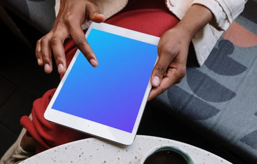 iPad Mini mockup front view in a black ladies hand