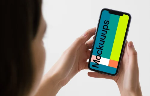 iPhone mockup held up by a woman