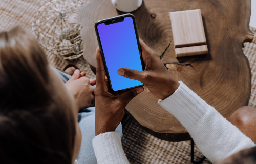 iPhone mockup in a ladies hand beside a friend.