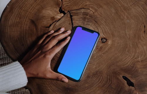 iPhone mockup on brown wooden center table