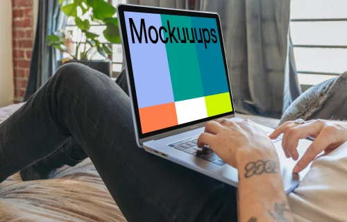 MacBook Pro mockup on man's legs in a bedroom