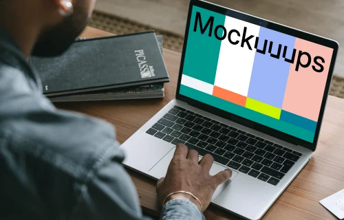 Man shopping on his grey MacBook mockup  