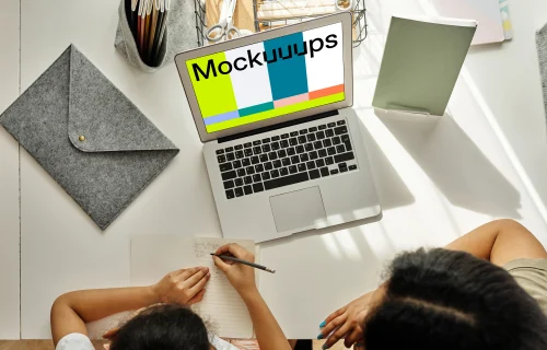 Mockup of adult teaching a kid using a MacBook Air