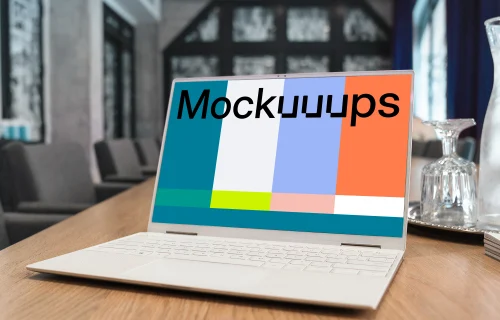 White Dell XPS Mockup on a table with wine glasses at the side