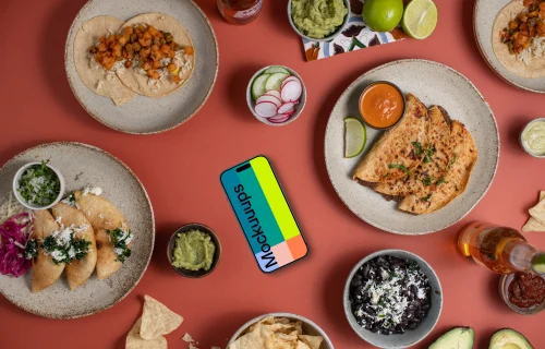 Phone mockup surrounded by Mexican food