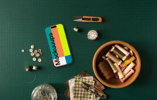 Smartphone mockup surrounded by sewing accessories