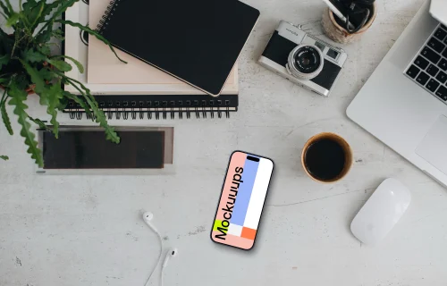 Smartphone mockup with headphones and MacBook Pro