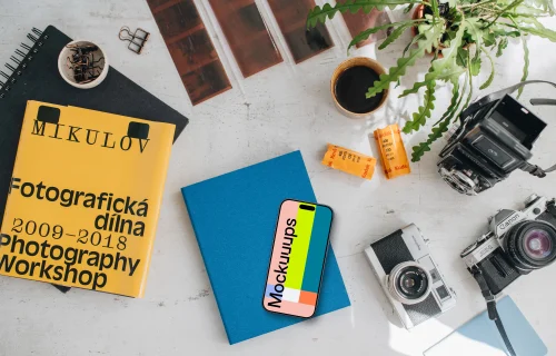 Top view of smartphone mockup with analog cameras and book