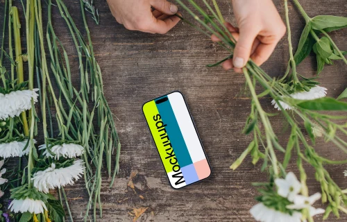 Top view of smartphone mockup with flowers