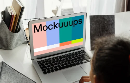 Young girl working on her MacBook Air mockup