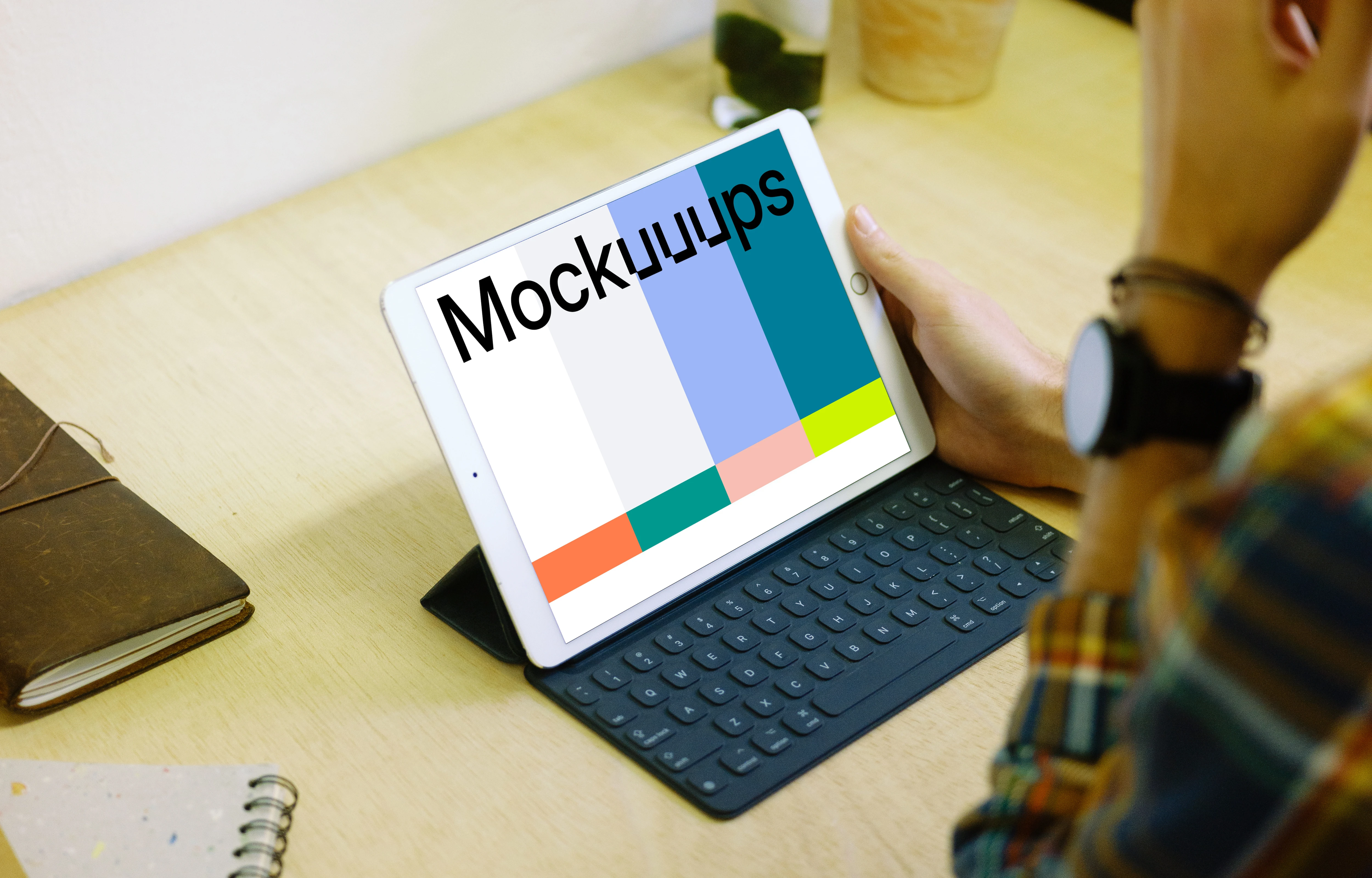 Holding iPad Pro mockup with keyboard
