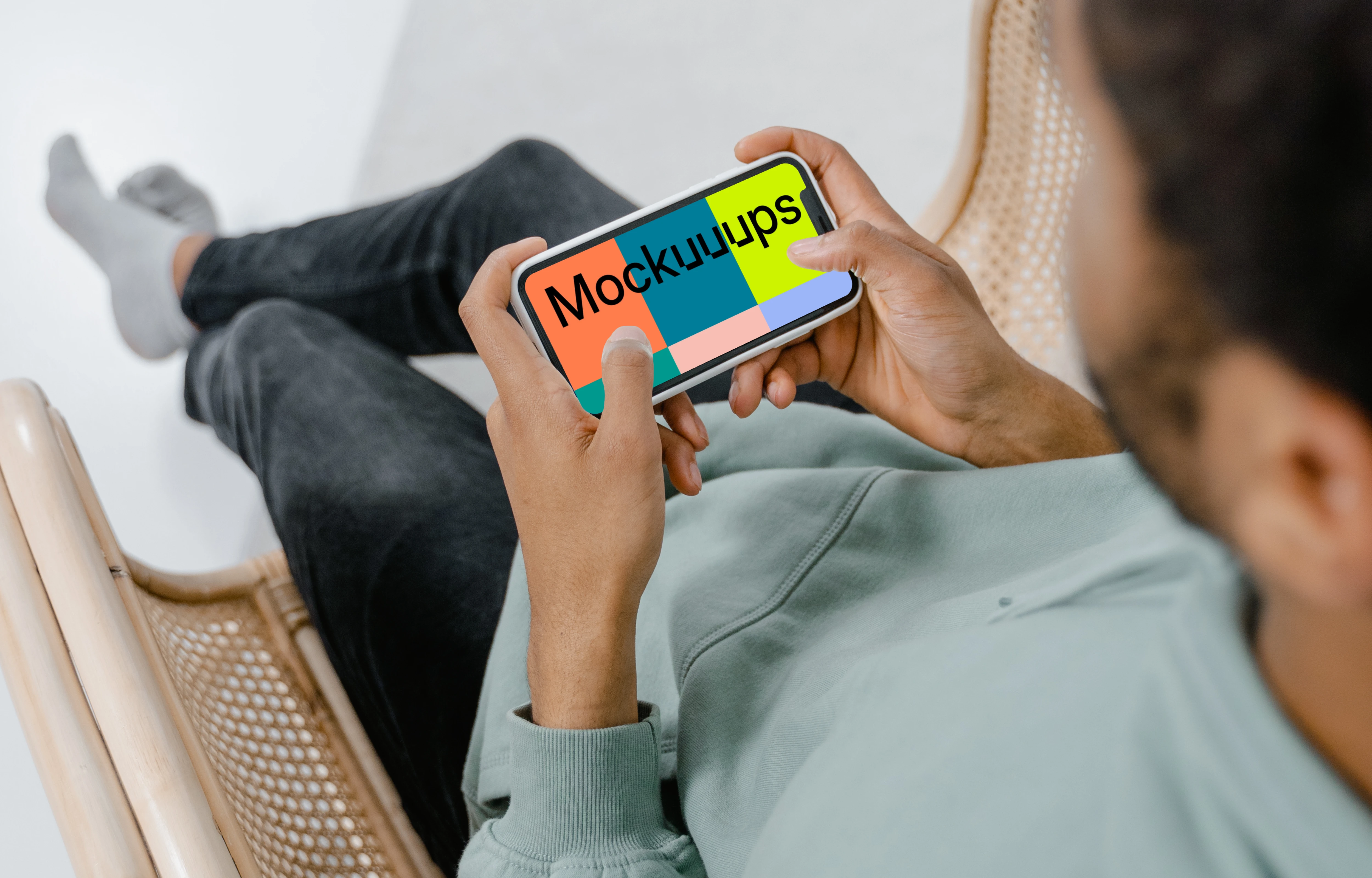 iPhone mockup held by user in landscape mode