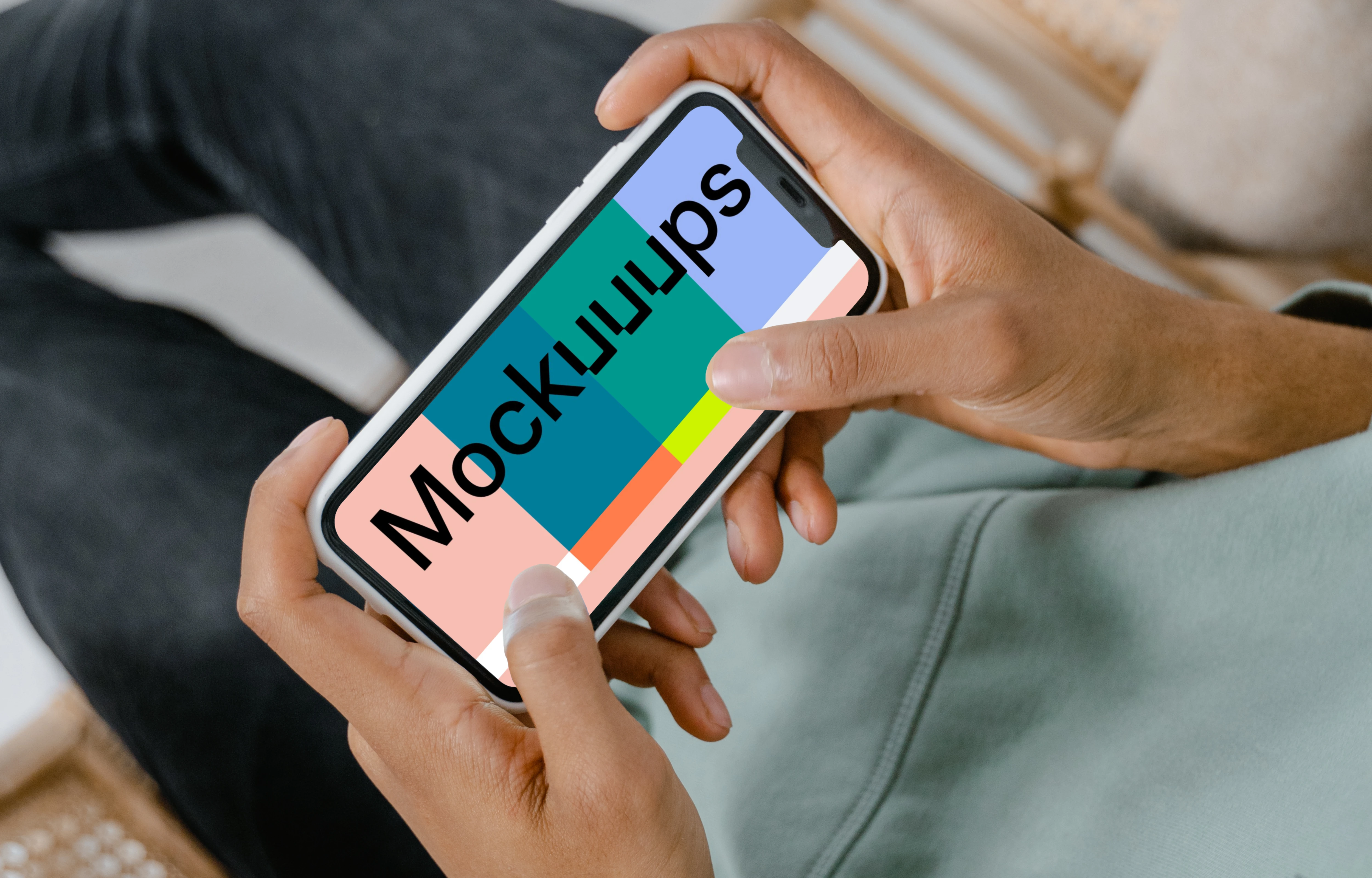 iPhone mockup held on a chair by user