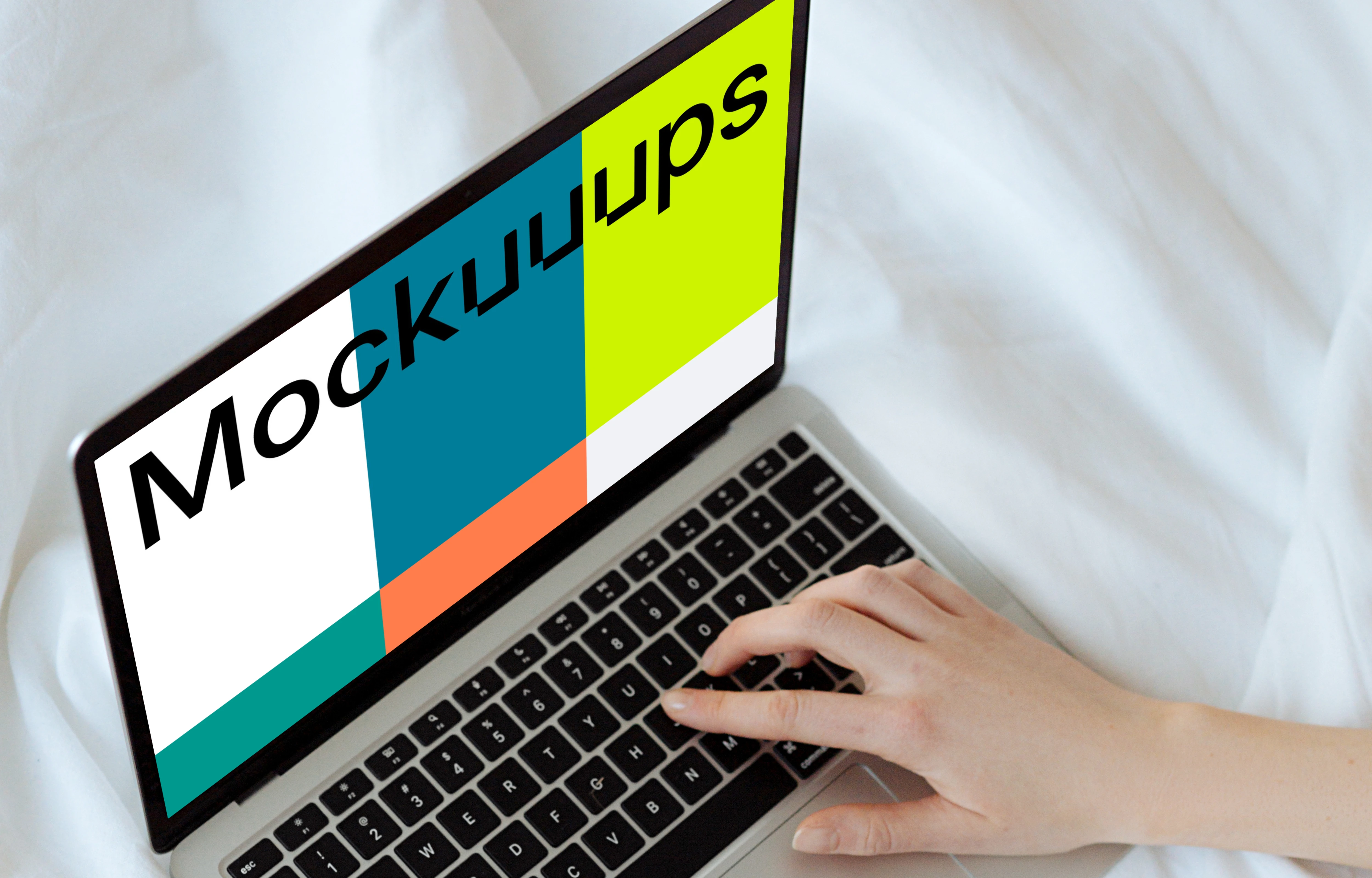 MacBook mockup on a white bed with a user typing on the laptop