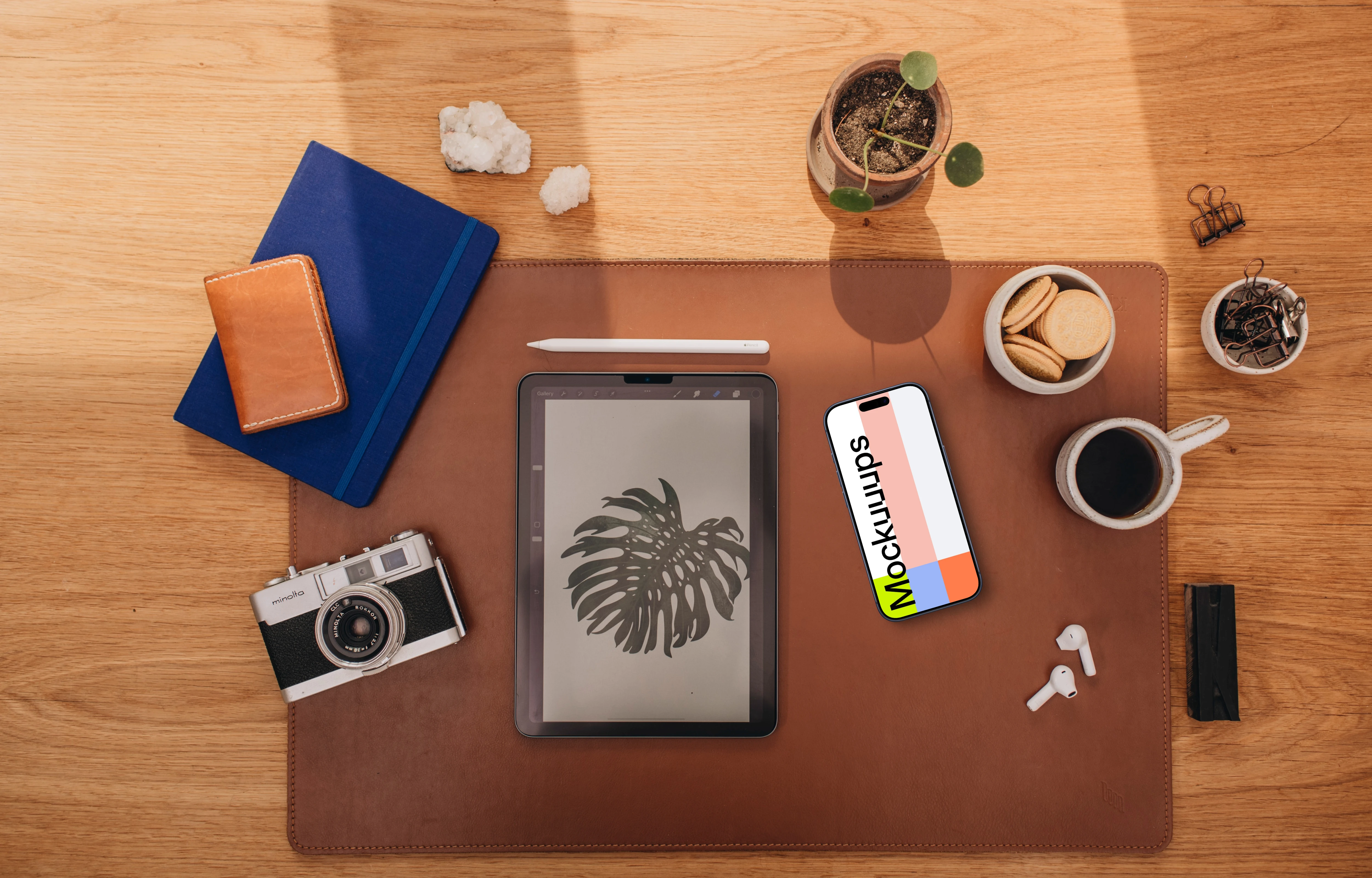 Mockup of phone next to the coffee and tablet
