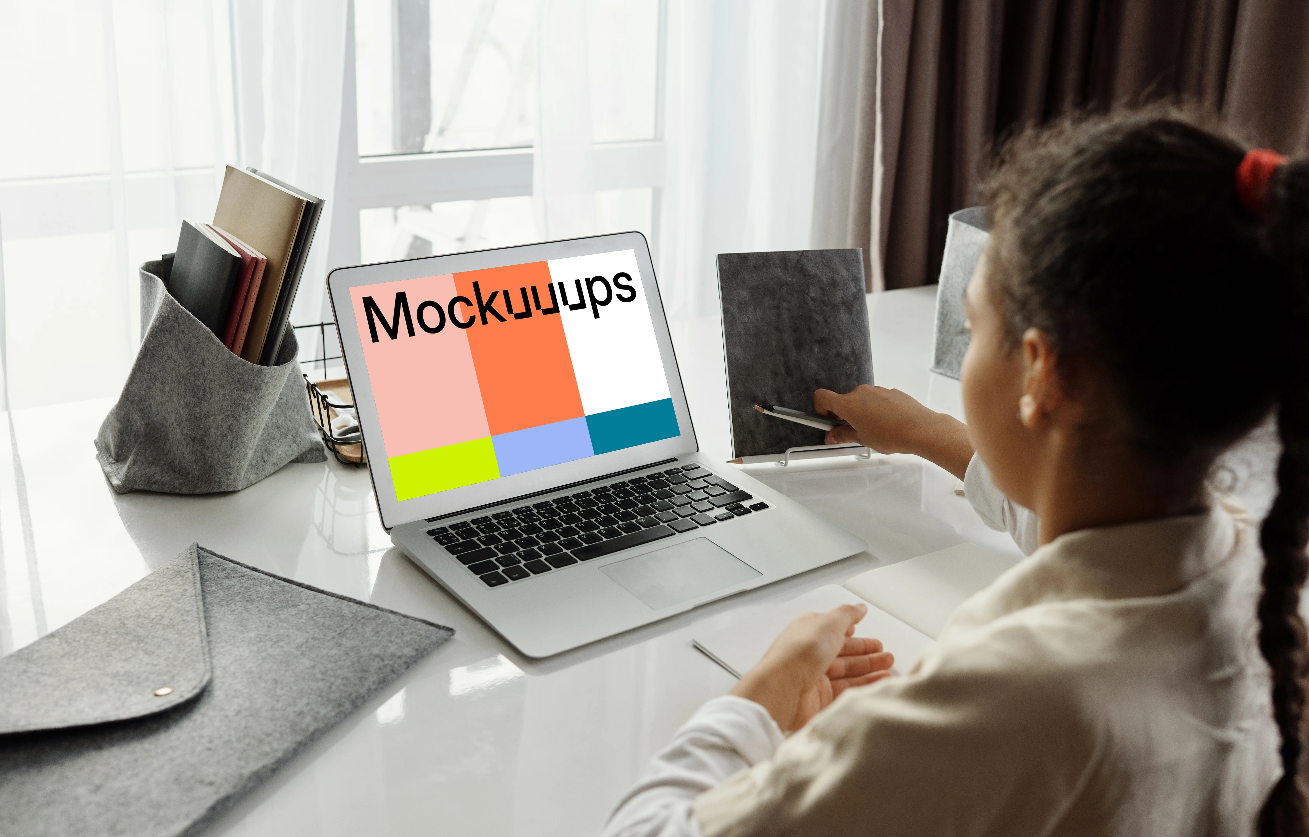 Mockup of young girl using a white MacBook Air