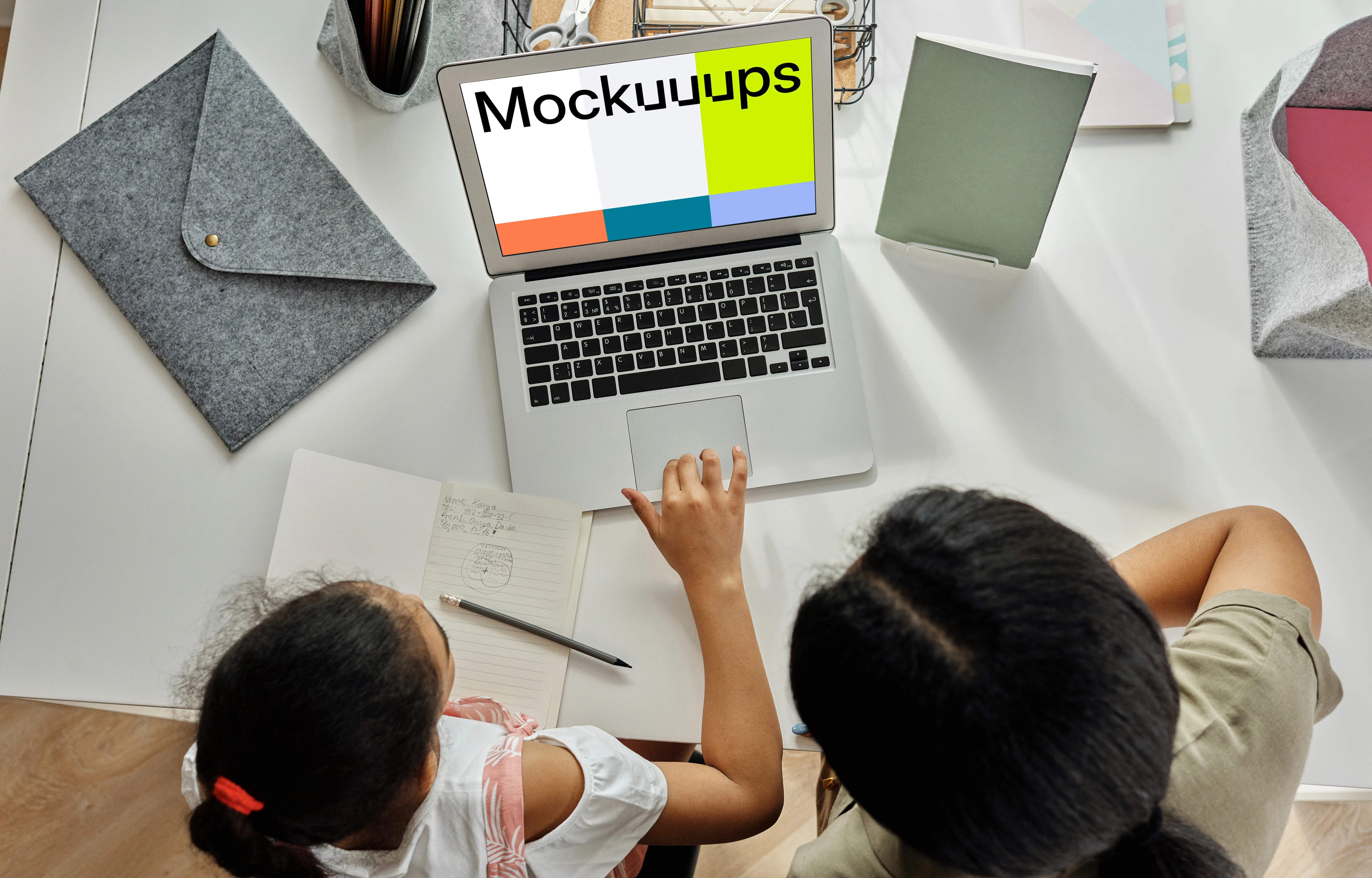 Adult teaching a young girl something on a MacBook Air mockup