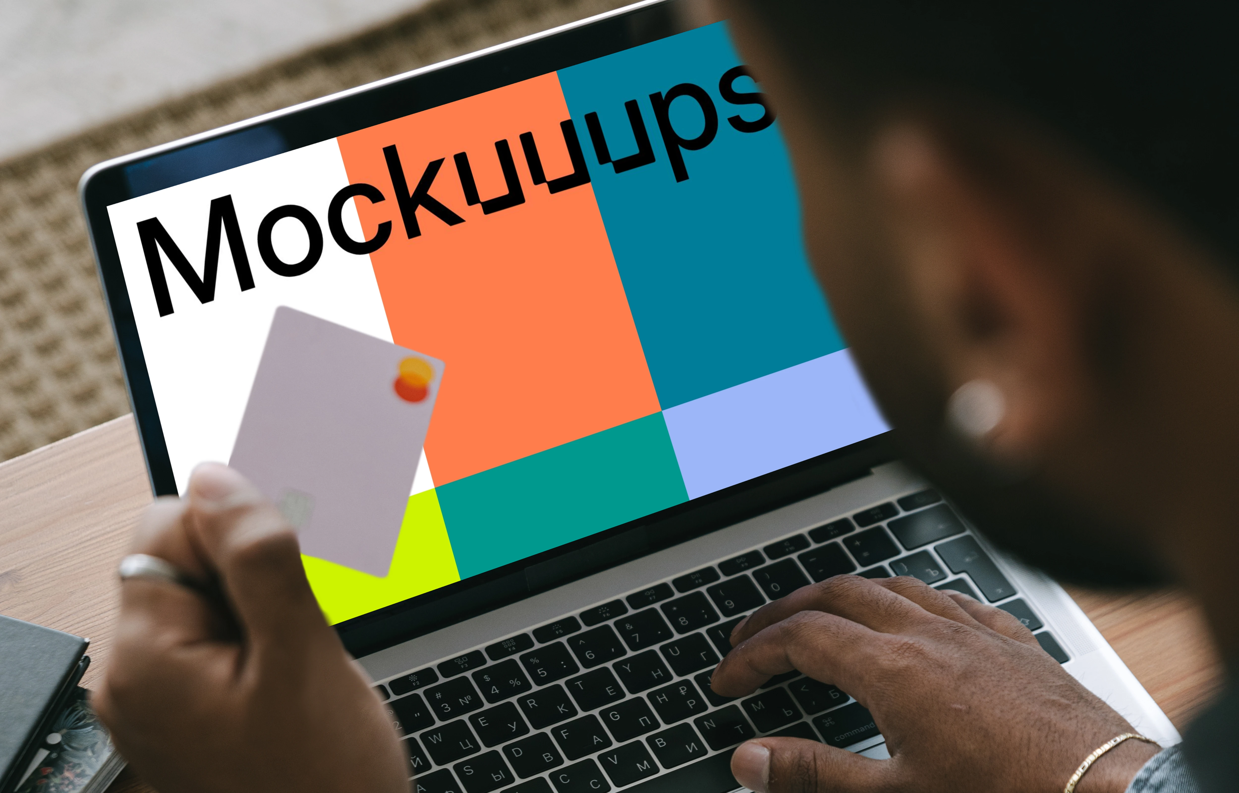 Mockup of man entering his card details into his MacBook 