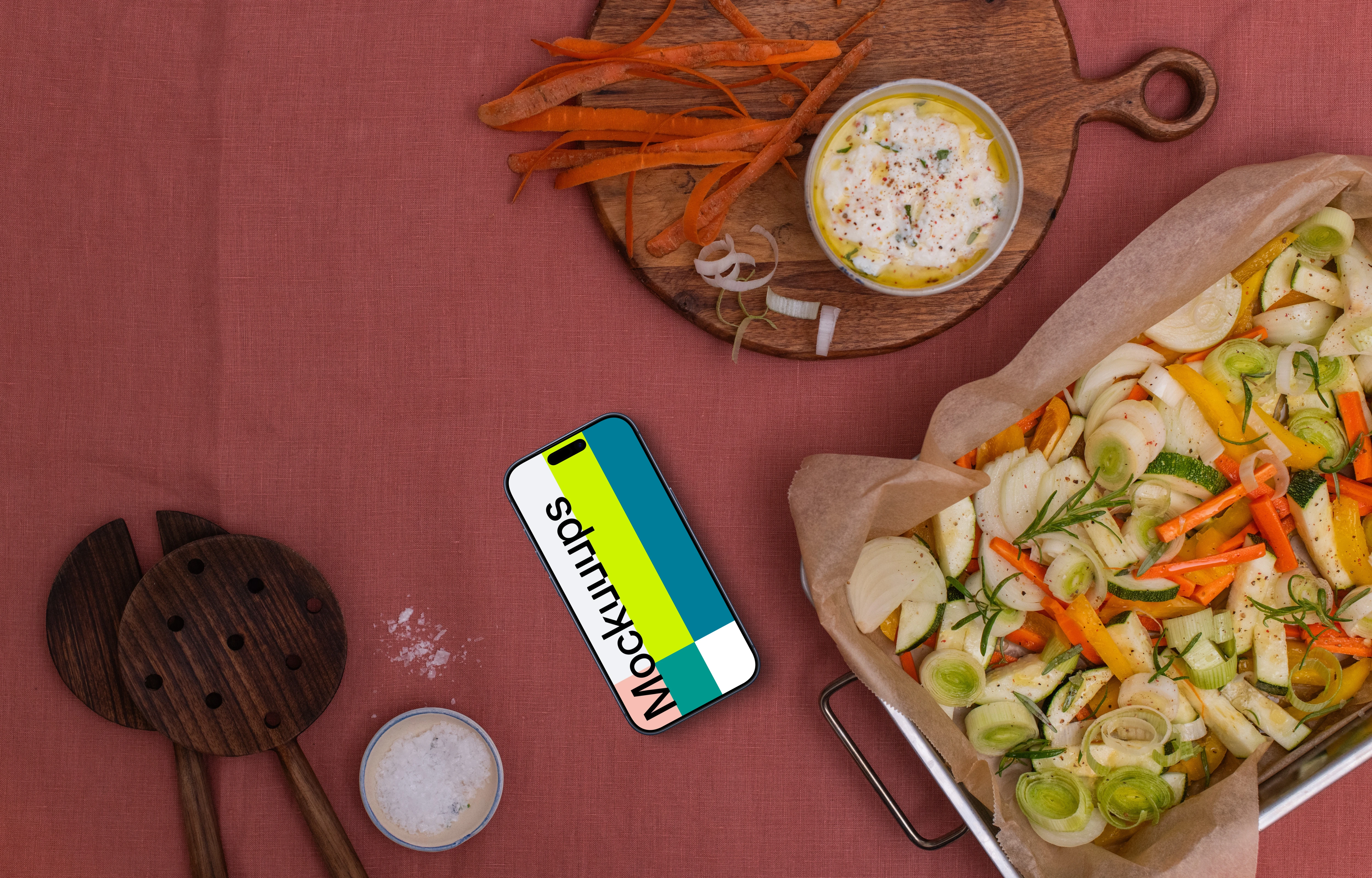 Baking pan full of vegetables and a phone mockup