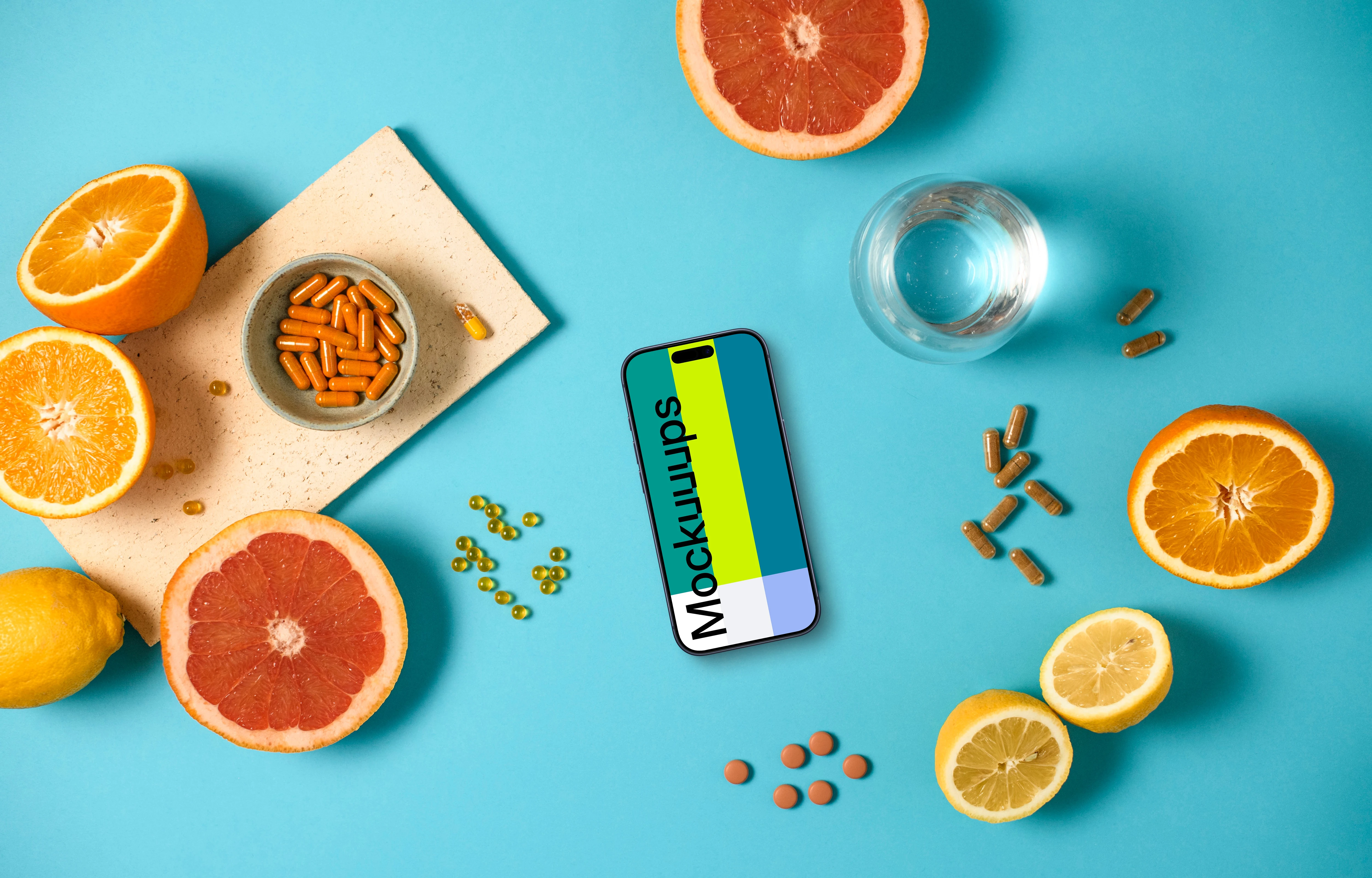 iPhone mockup with oranges and pills