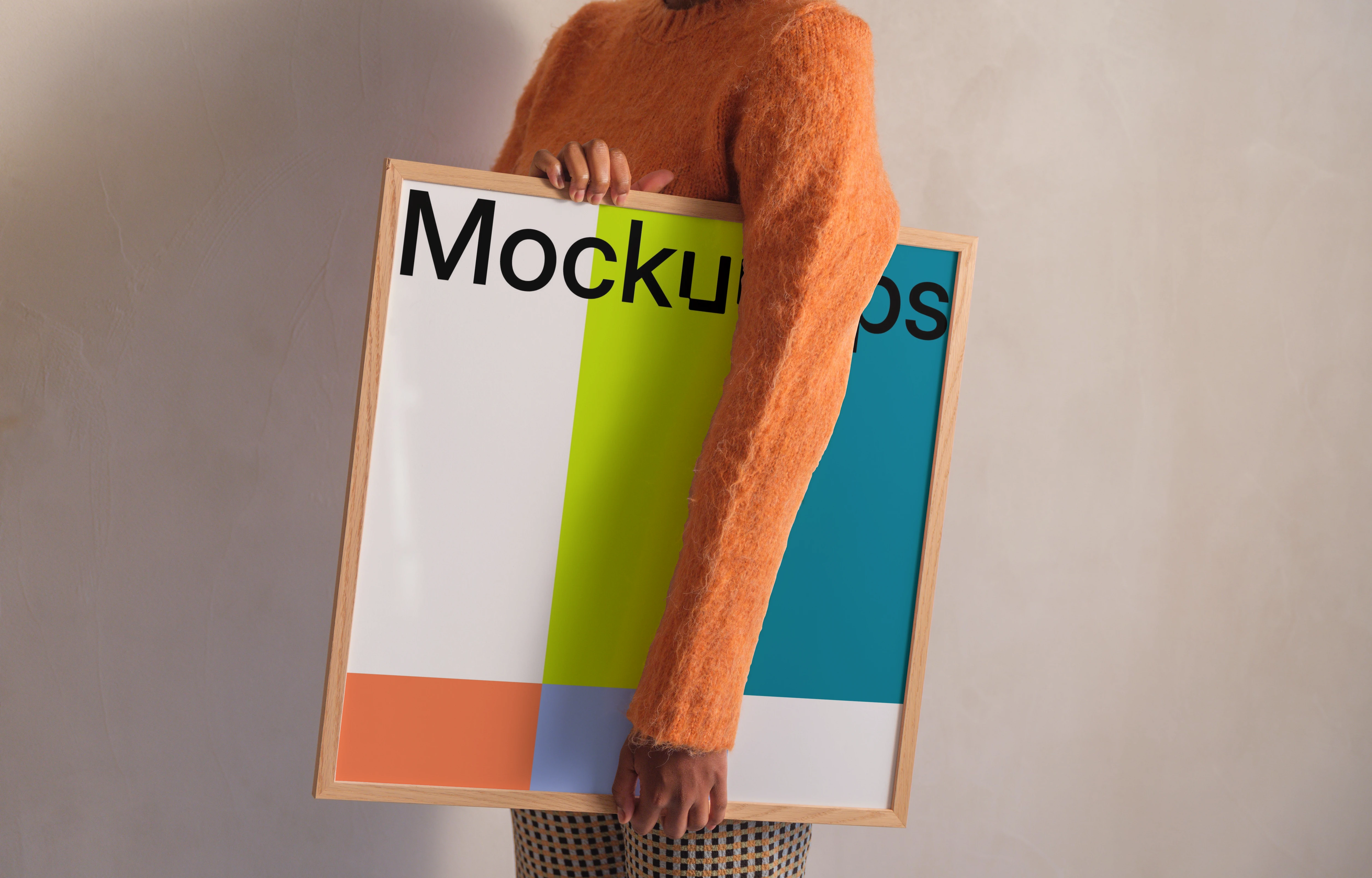 Framed mockup held by person in casual outfit