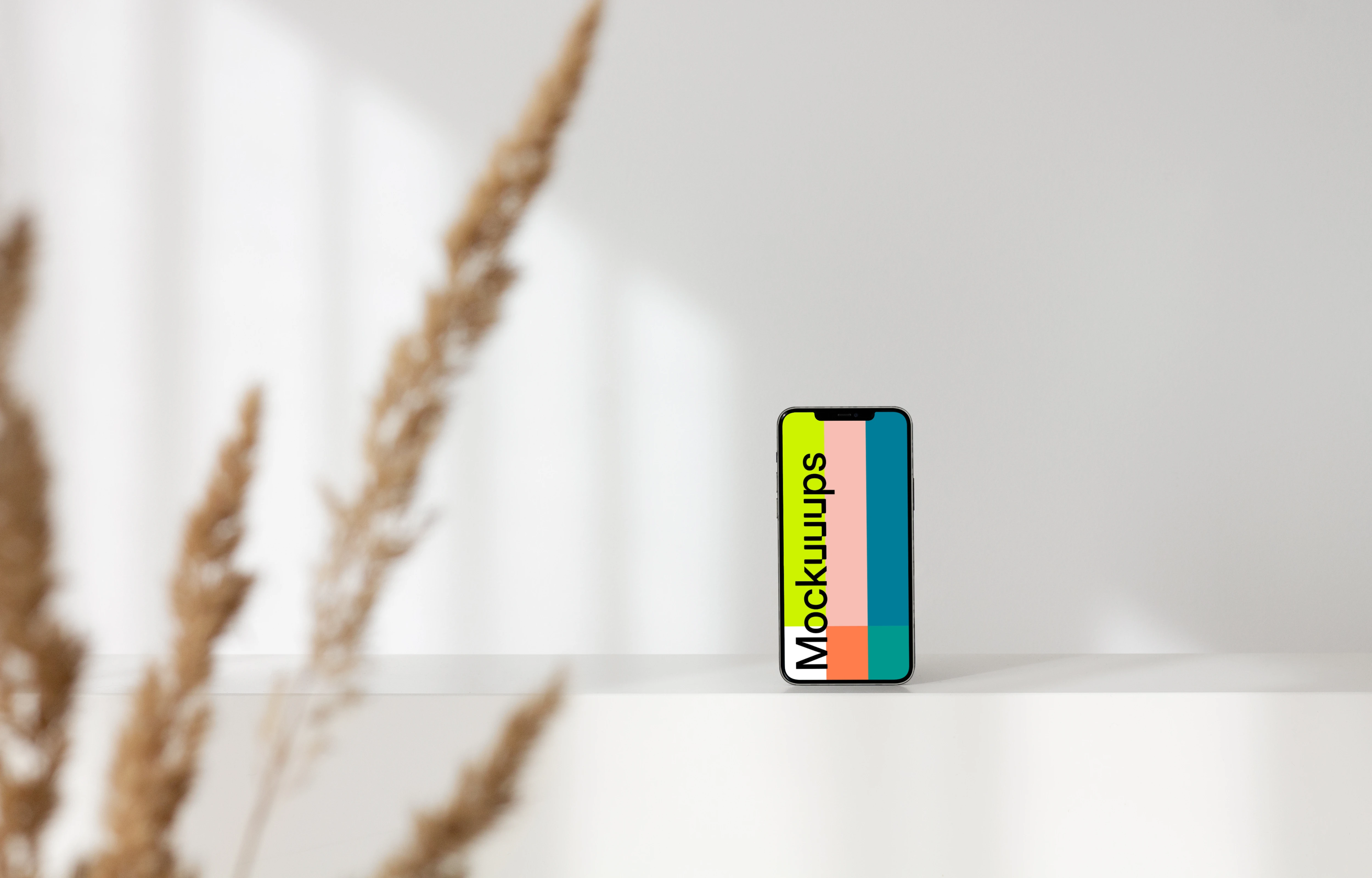 iPhone leaning on a white wall mockup