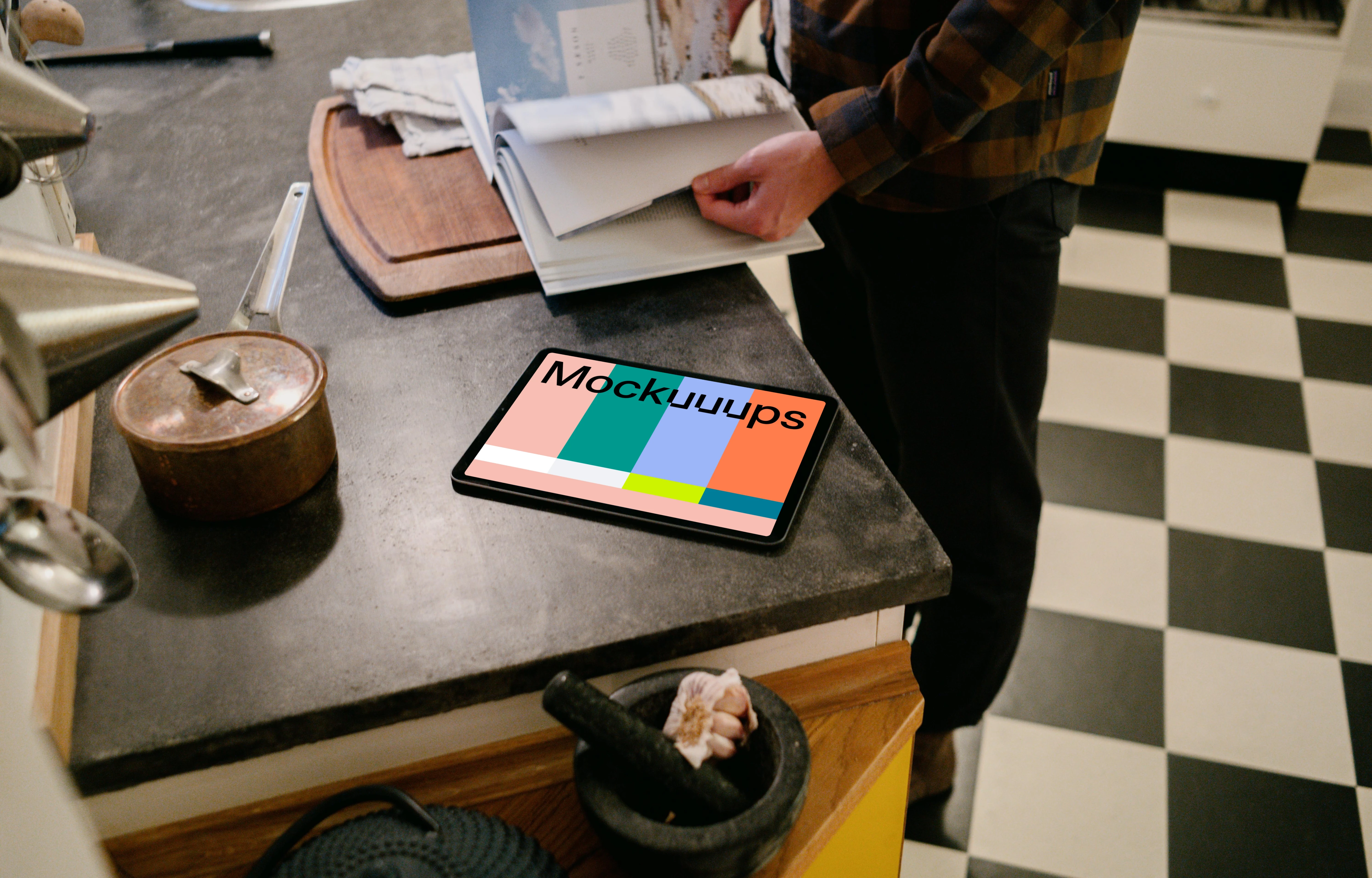 iPad Air mockup on a kitchen table beside a male user.