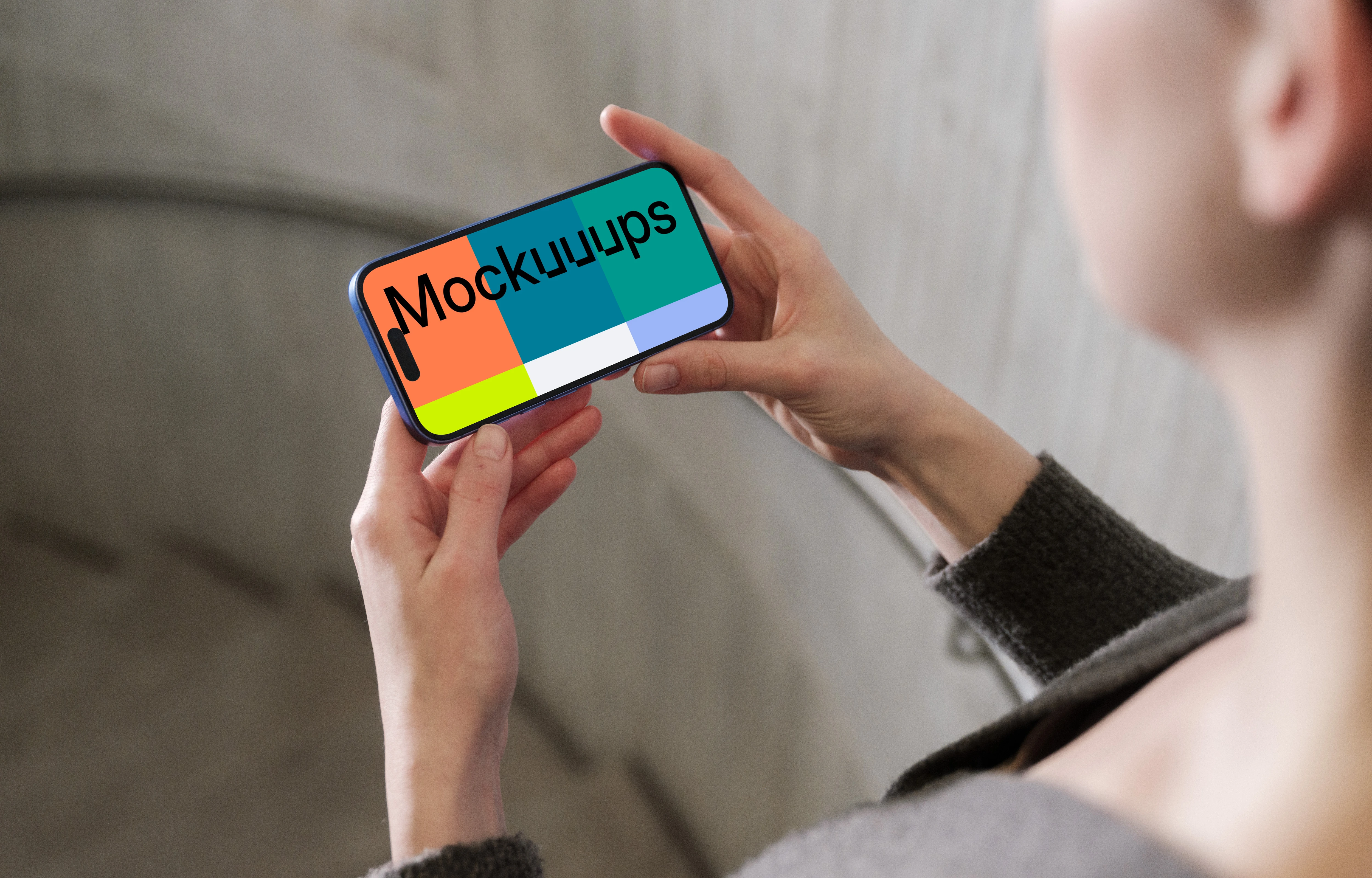 iPhone 16 mockup in a hand against concrete backdrop