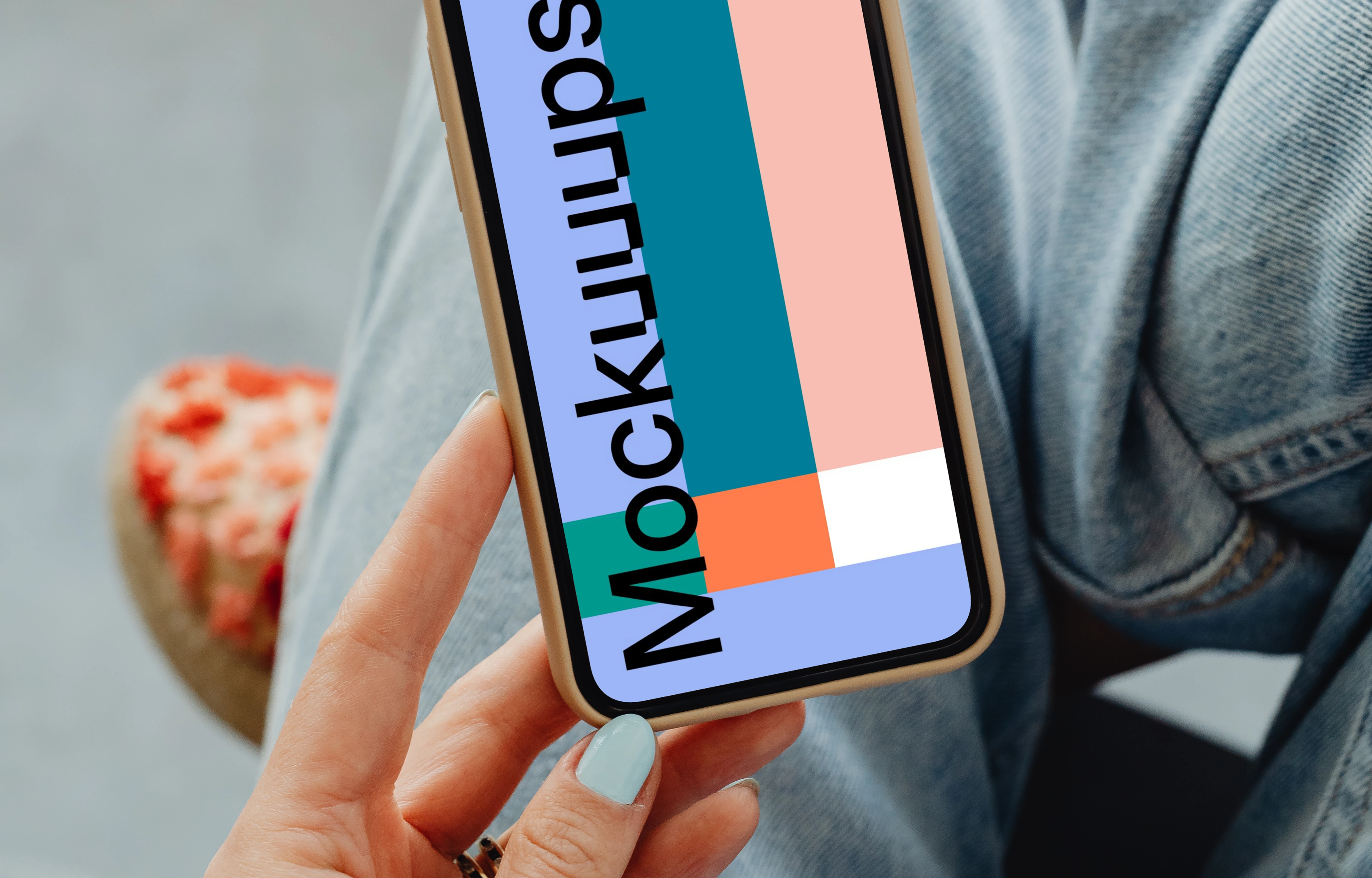 iPhone mockup hand held by user above her laps