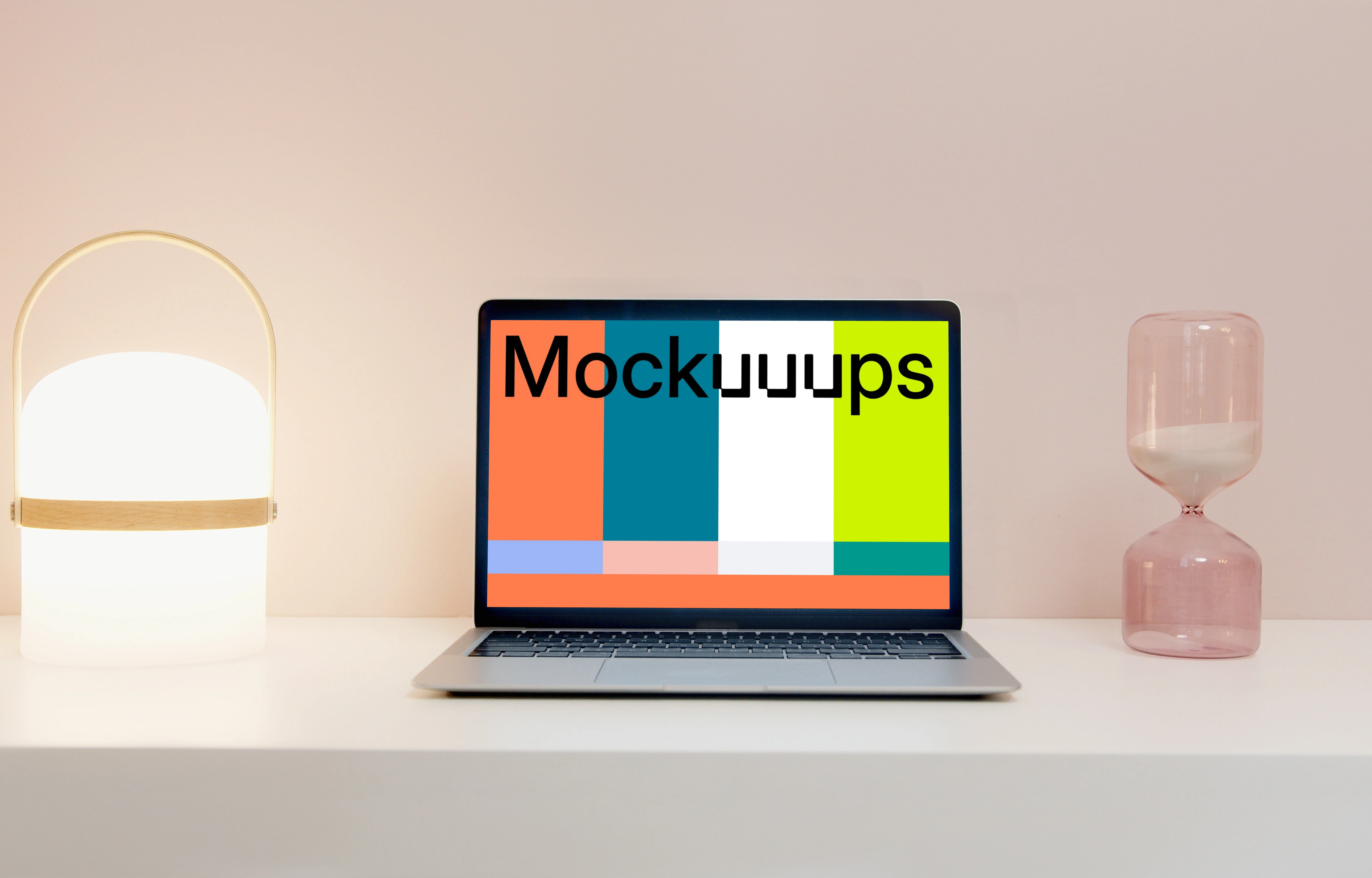 MacBook Pro mockup on a table beside an hourglass