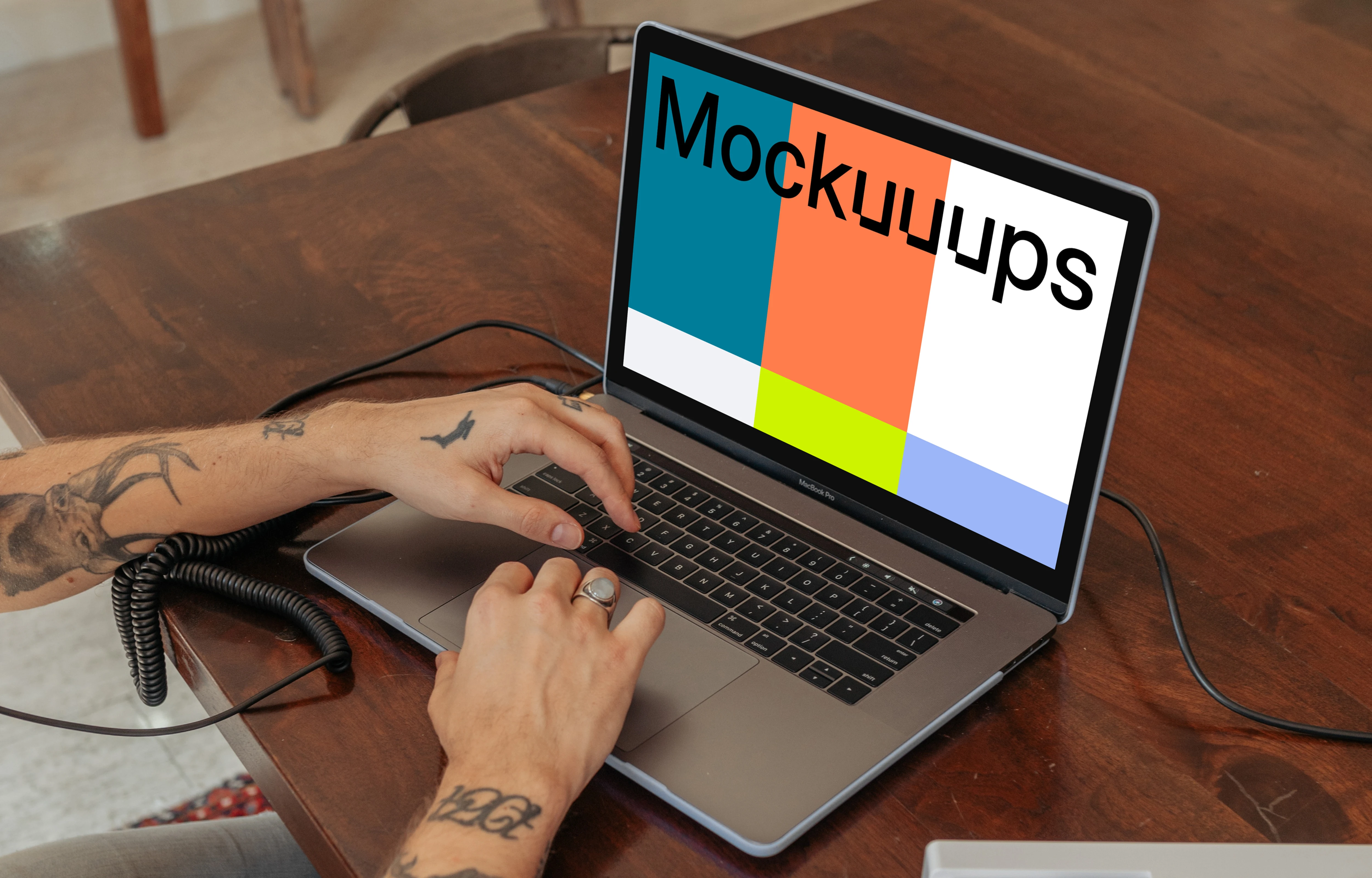 MacBook Pro mockup on a table with a mini-piano by the side