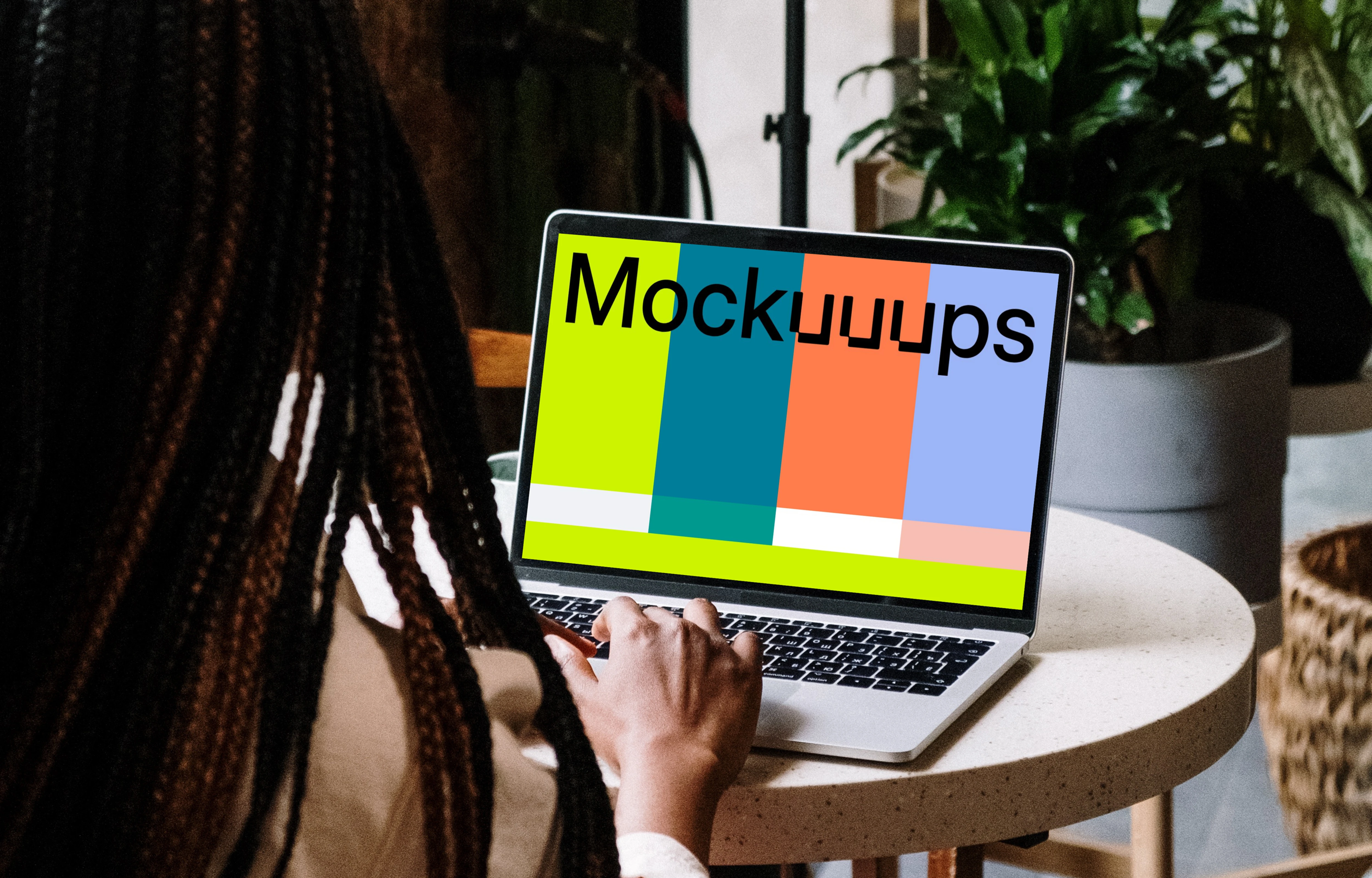 MacBook Pro mockup on white table with notebook by the side