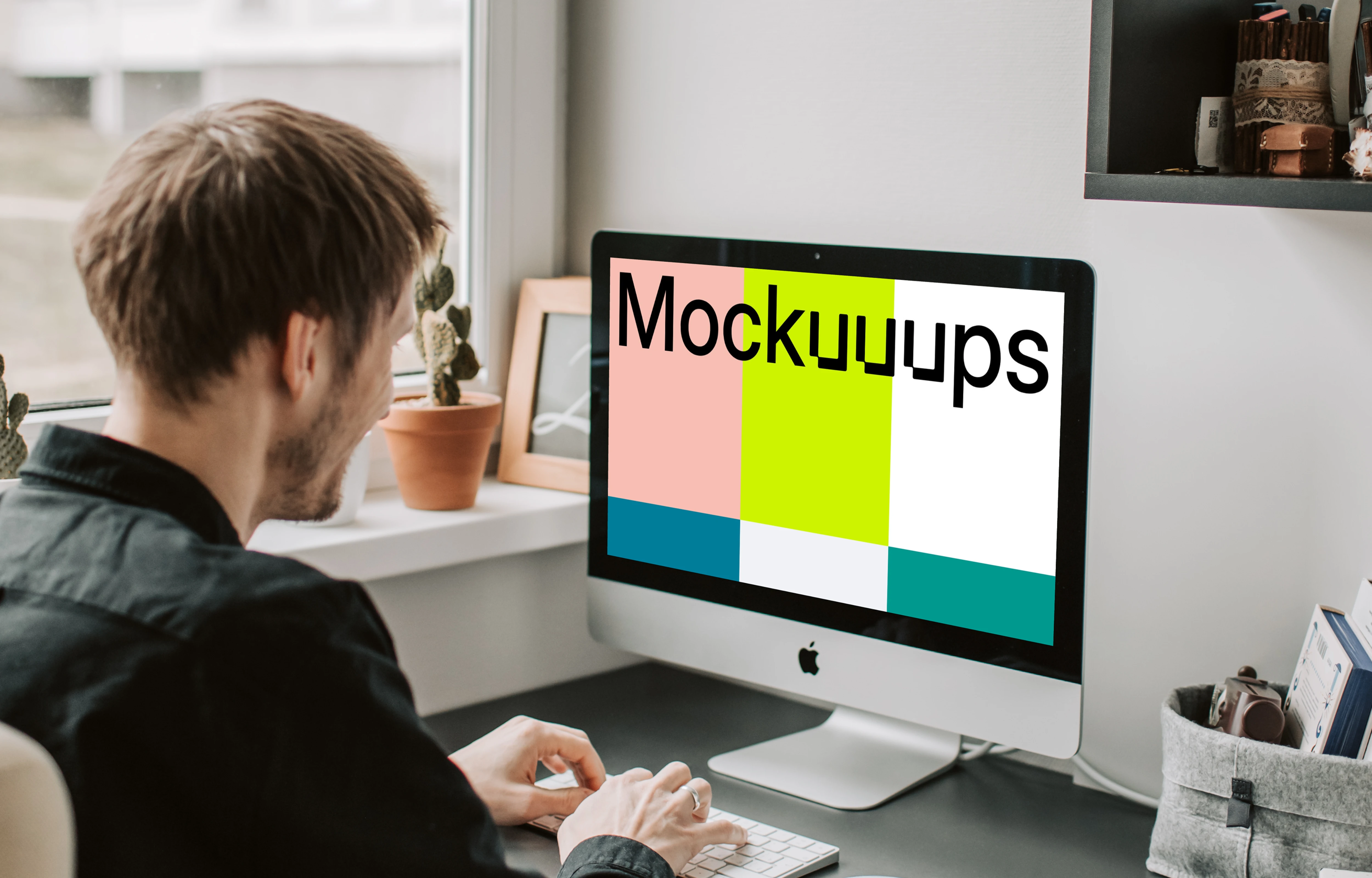 Man typing into his iMac mockup