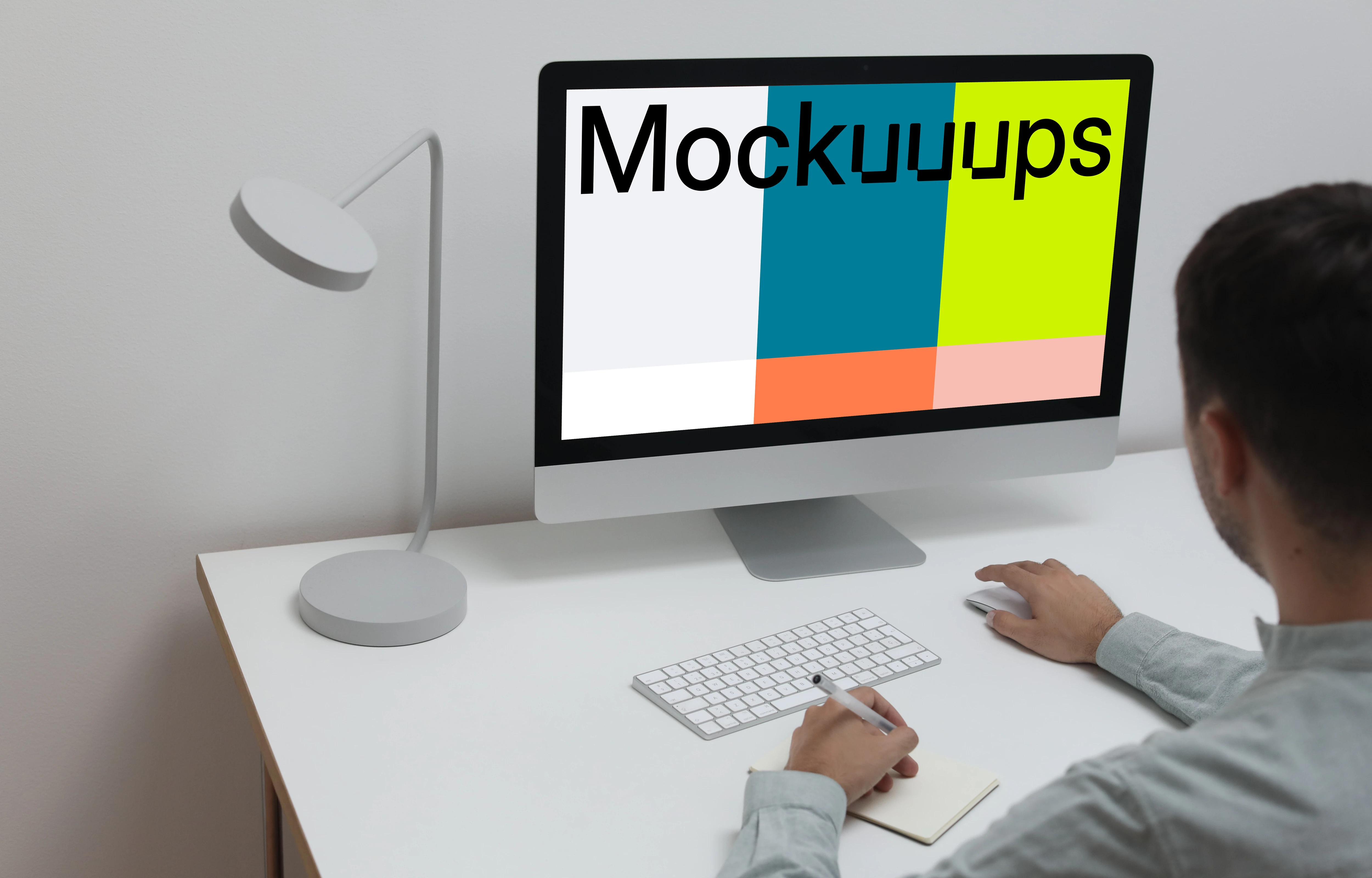 Mockup user using an iMac and writing into a notepad