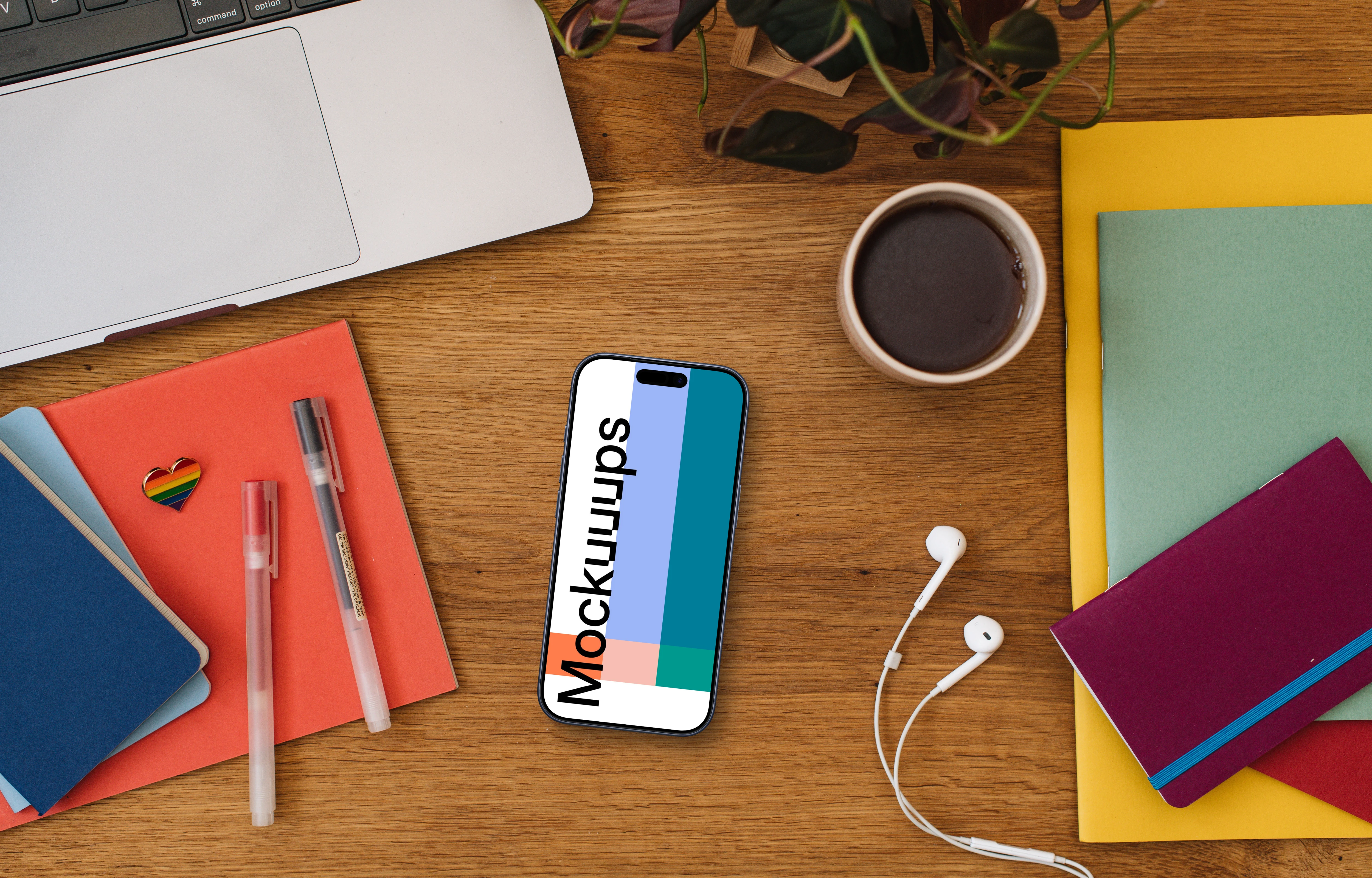 Smartphone mockup on a wooden table together with LGBT pin