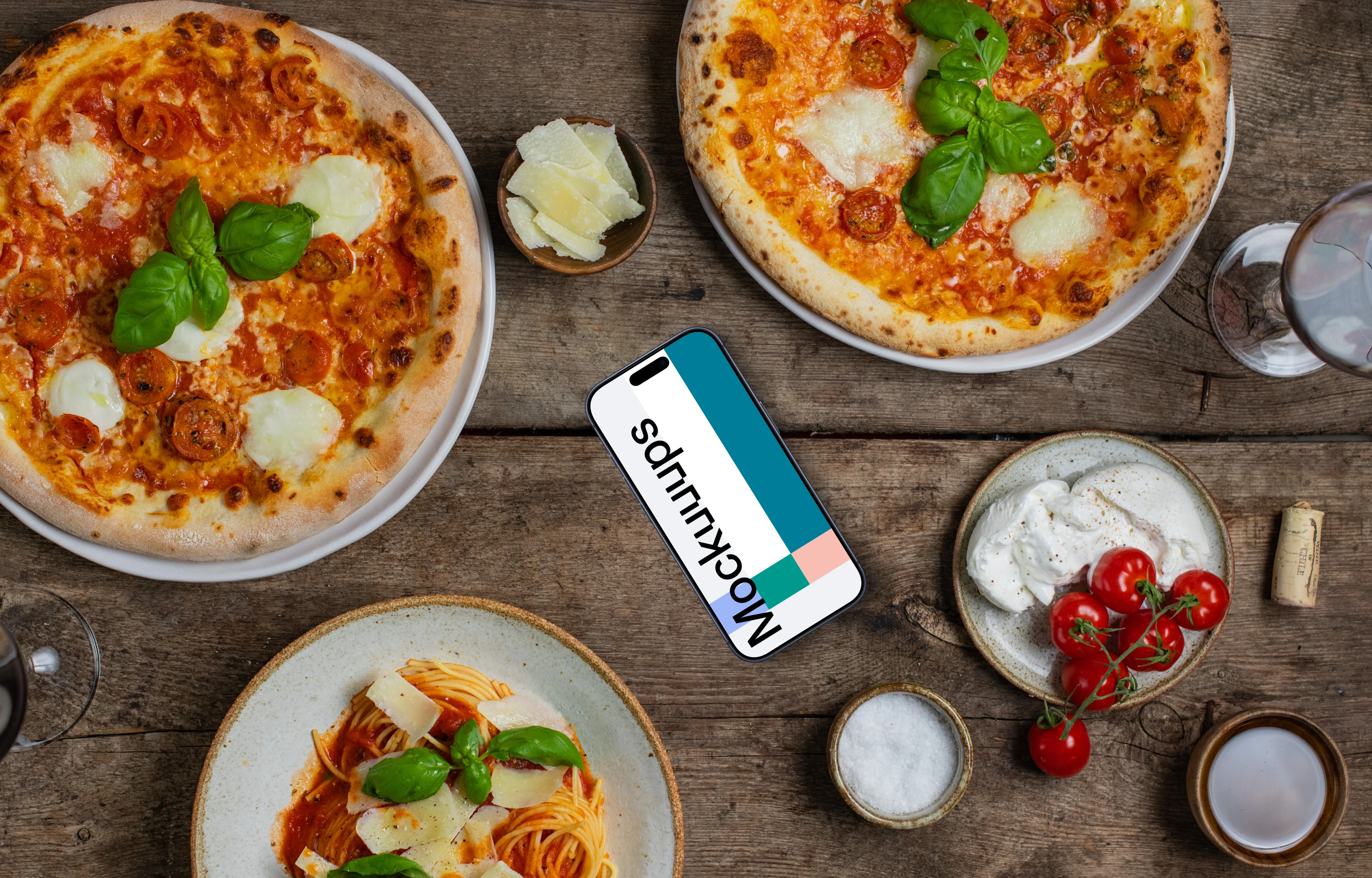 Phone mockup nearby pizza and pasta