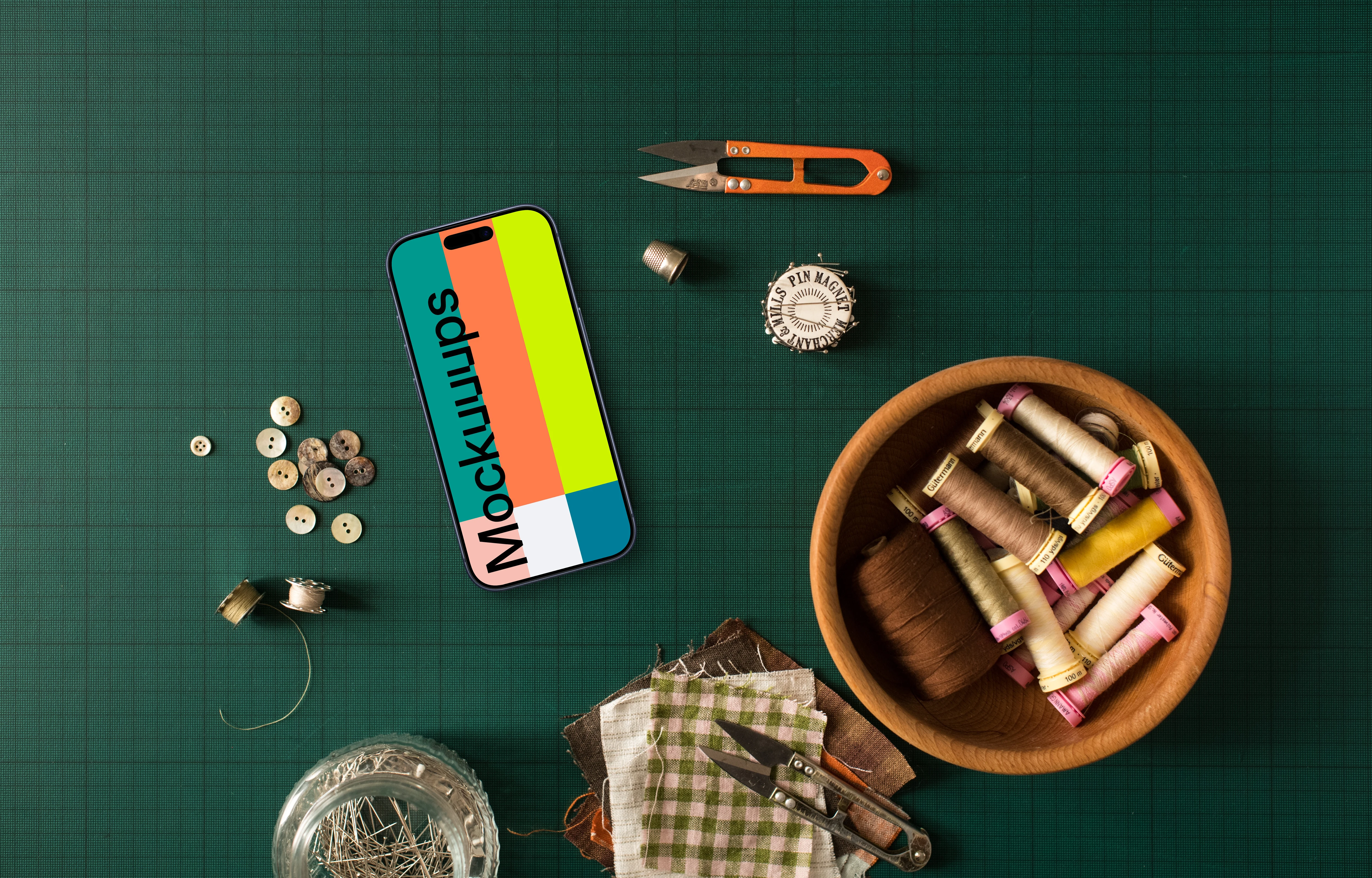 Smartphone mockup surrounded by sewing accessories