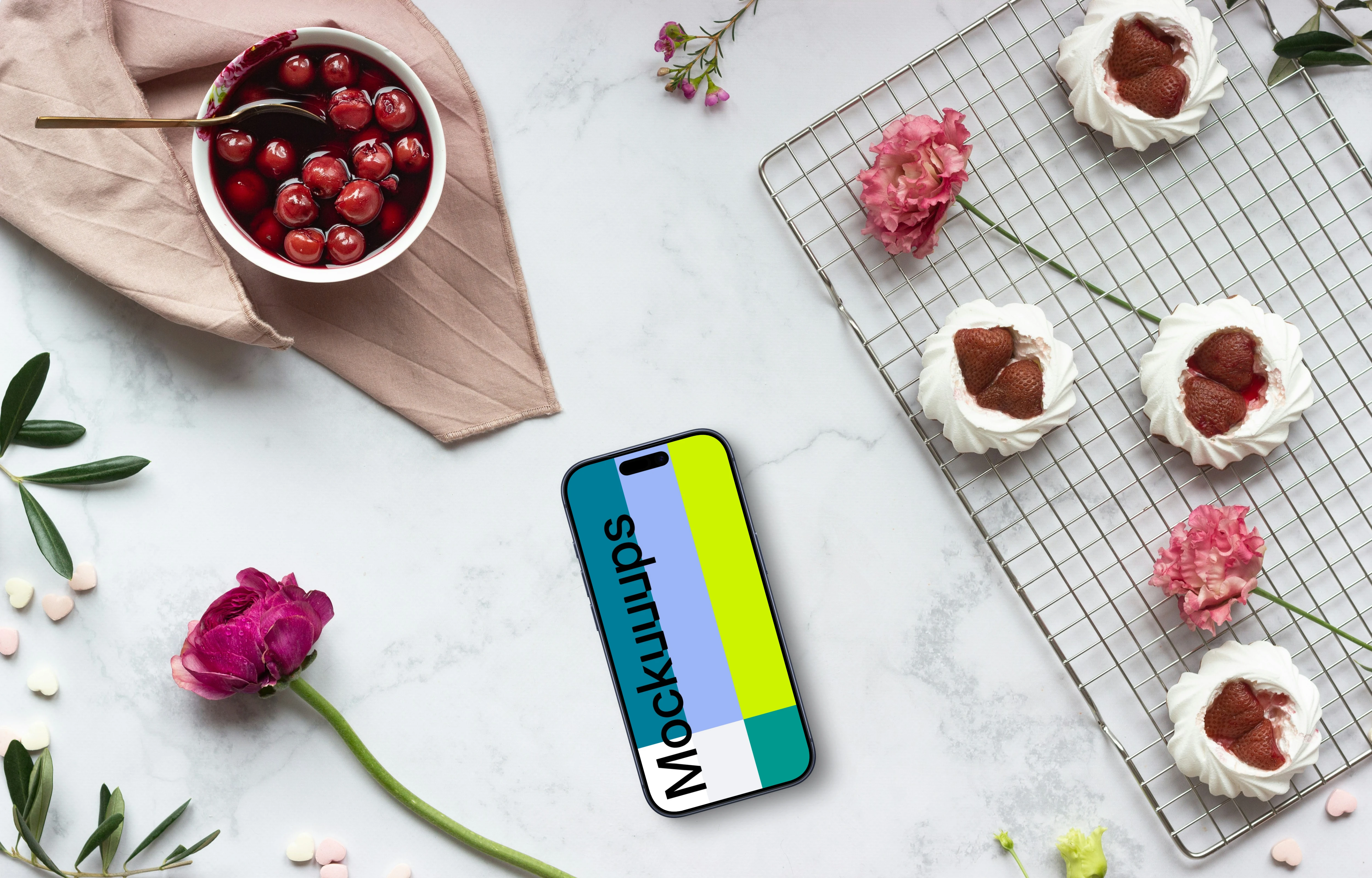 Smartphone mockup with pink flowers and desserts