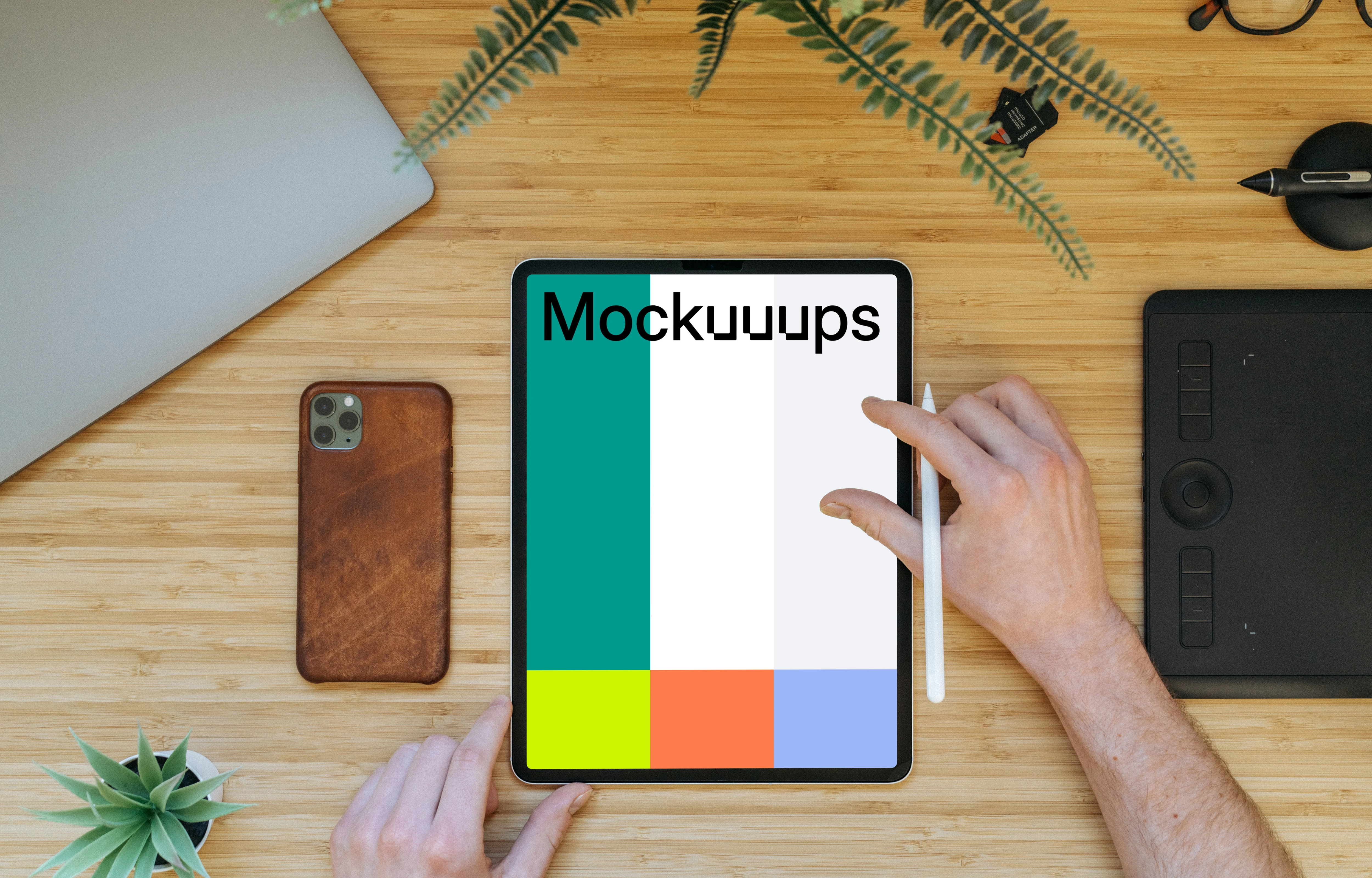 Tablet mockup on a wooden table with iPhone 11 at the side