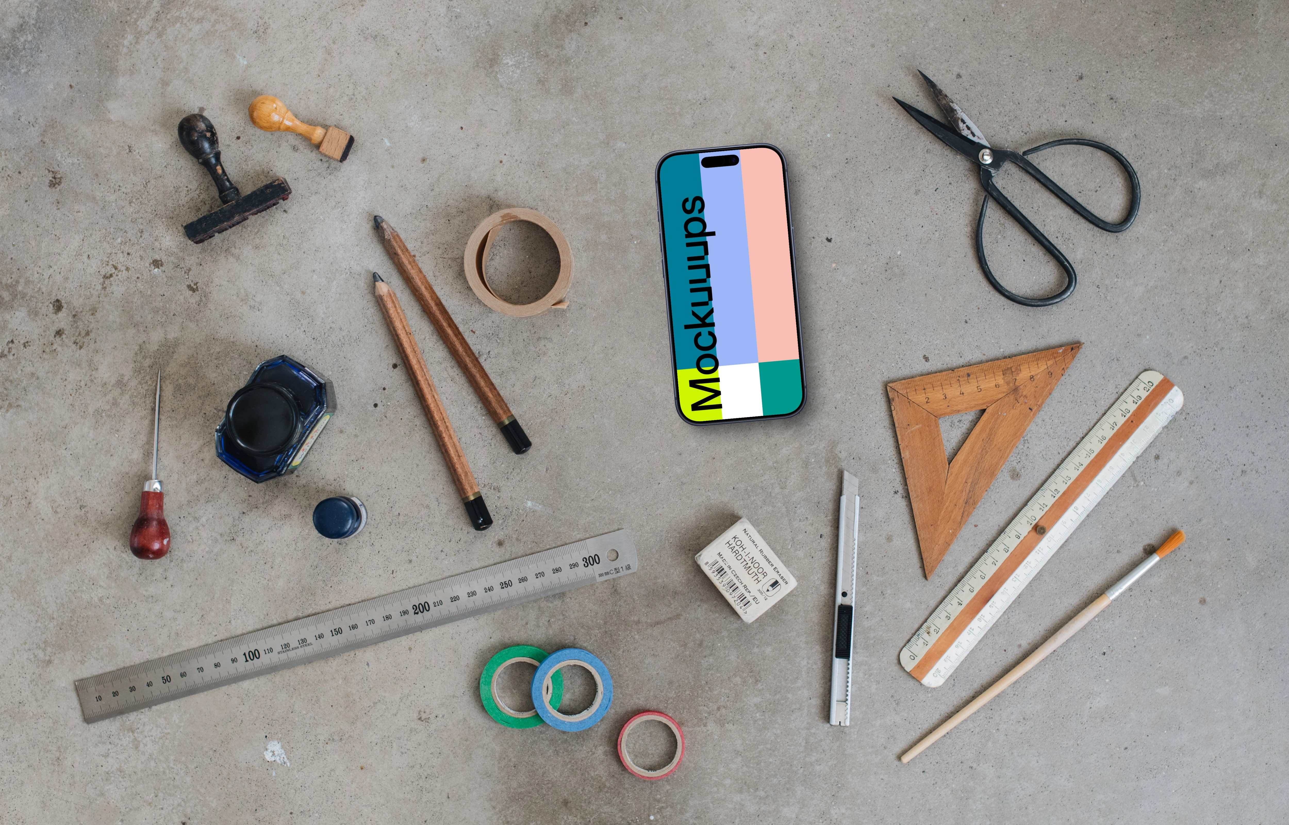 Top view of phone mockup with a ruler and scissors