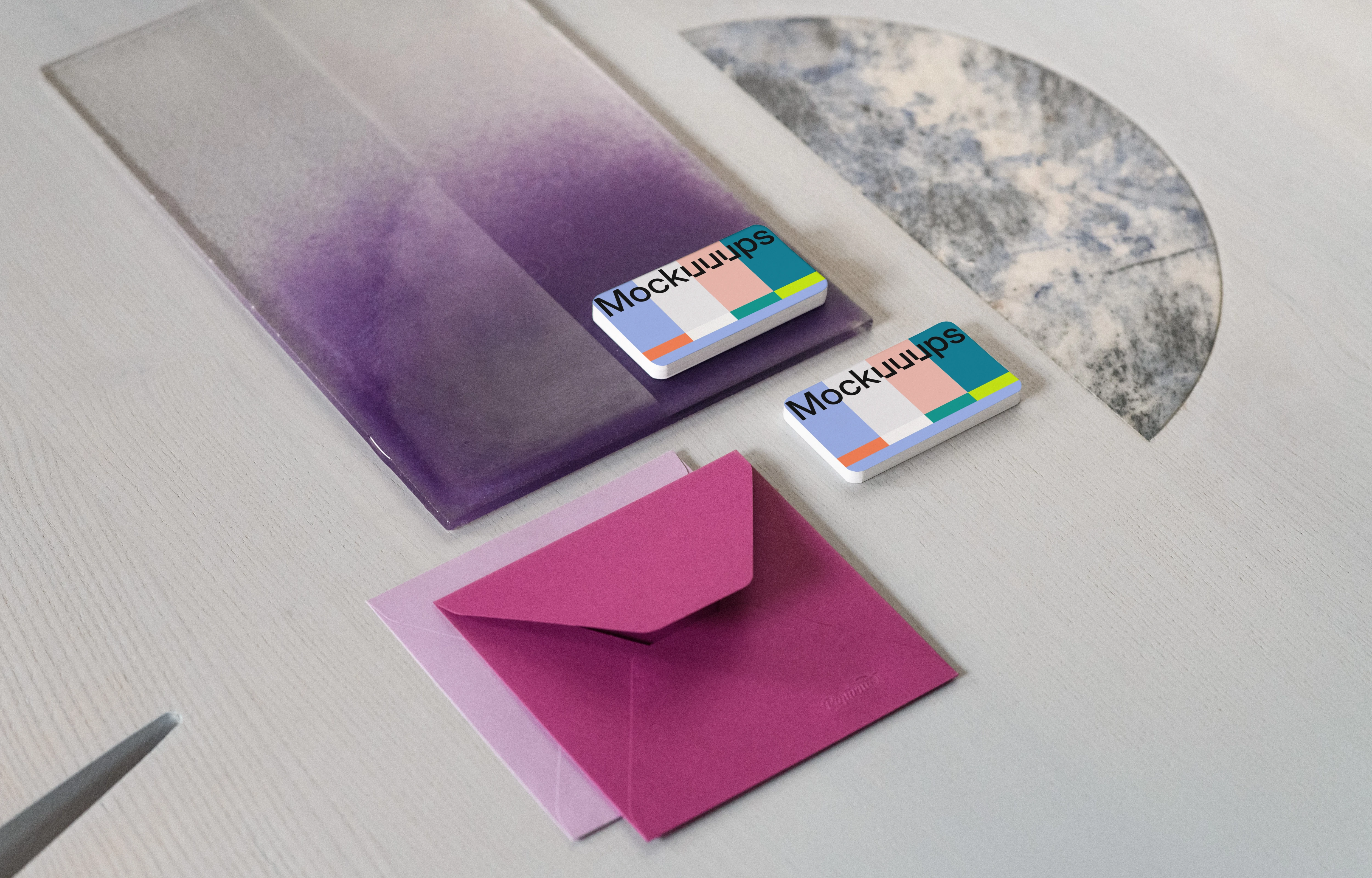 Two business cards mockup with colorful envelopes on textured surface