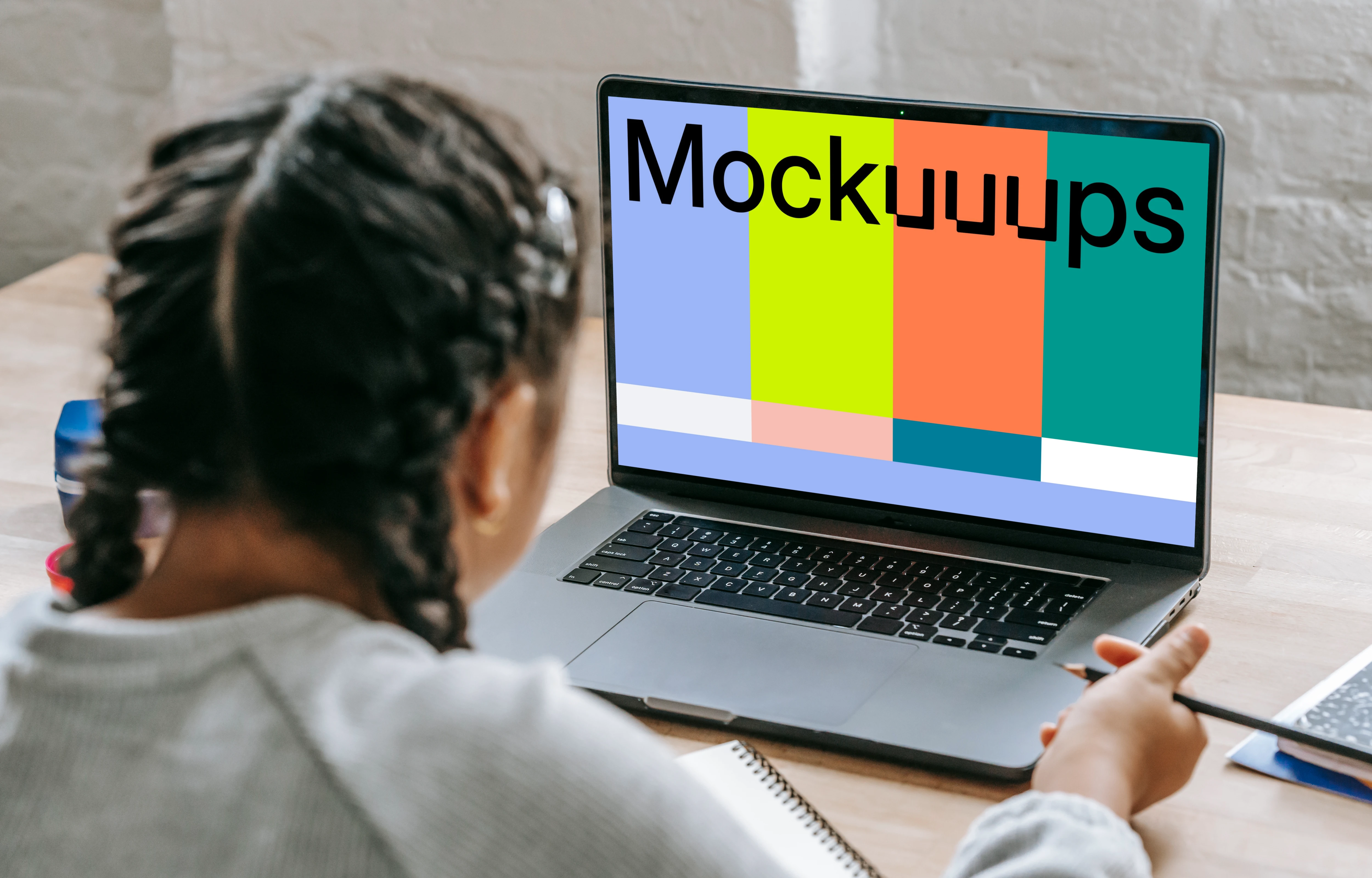 Young girl studying with a MacBook Pro mockup