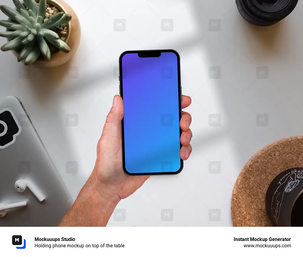 Holding phone mockup on top of the table