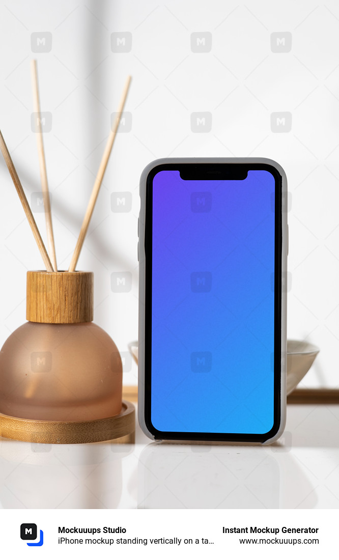 iPhone mockup standing vertically on a table next to a vase with empty sticks in them.