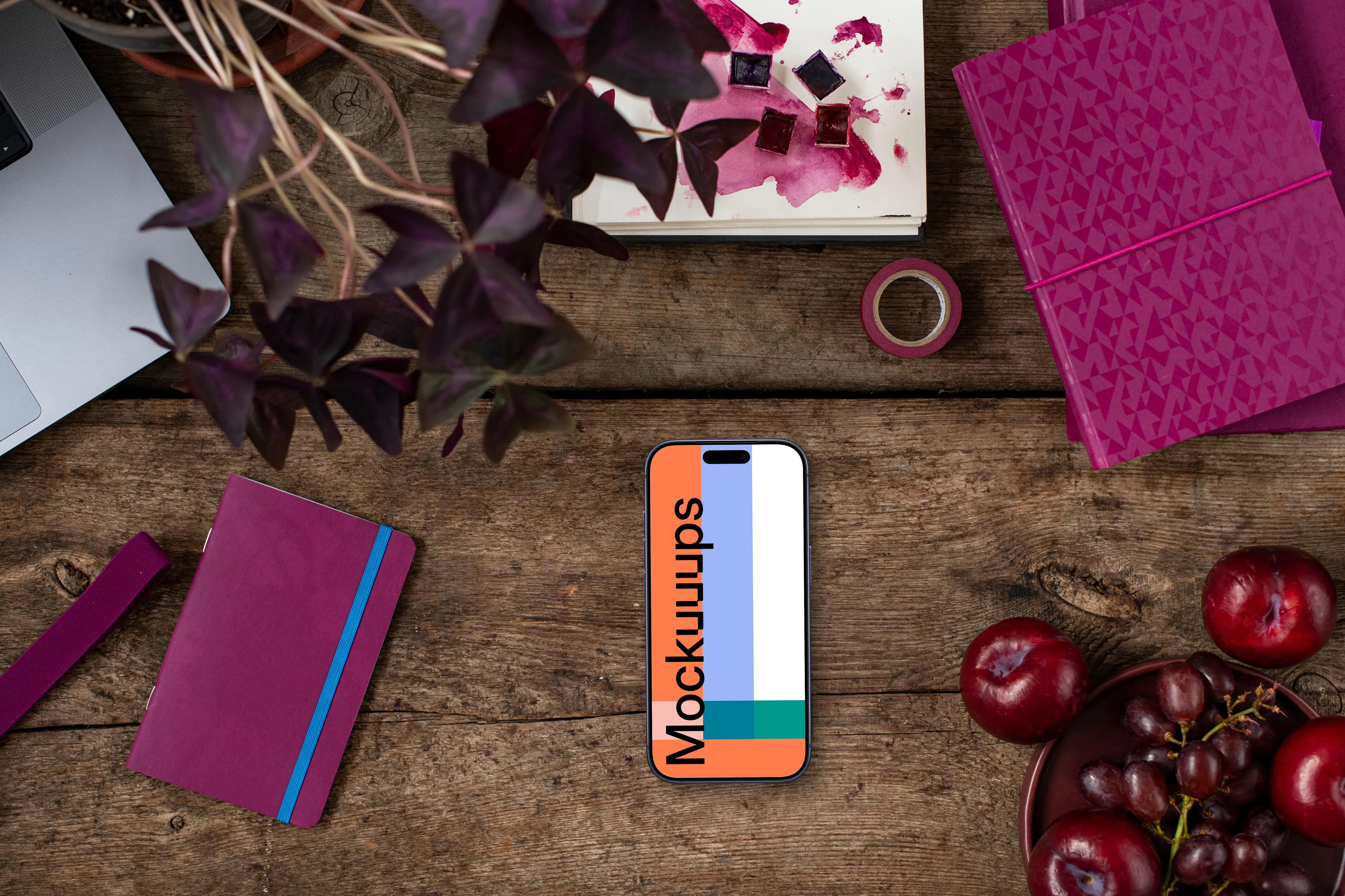 Books in Viva Magenta shades next to the phone