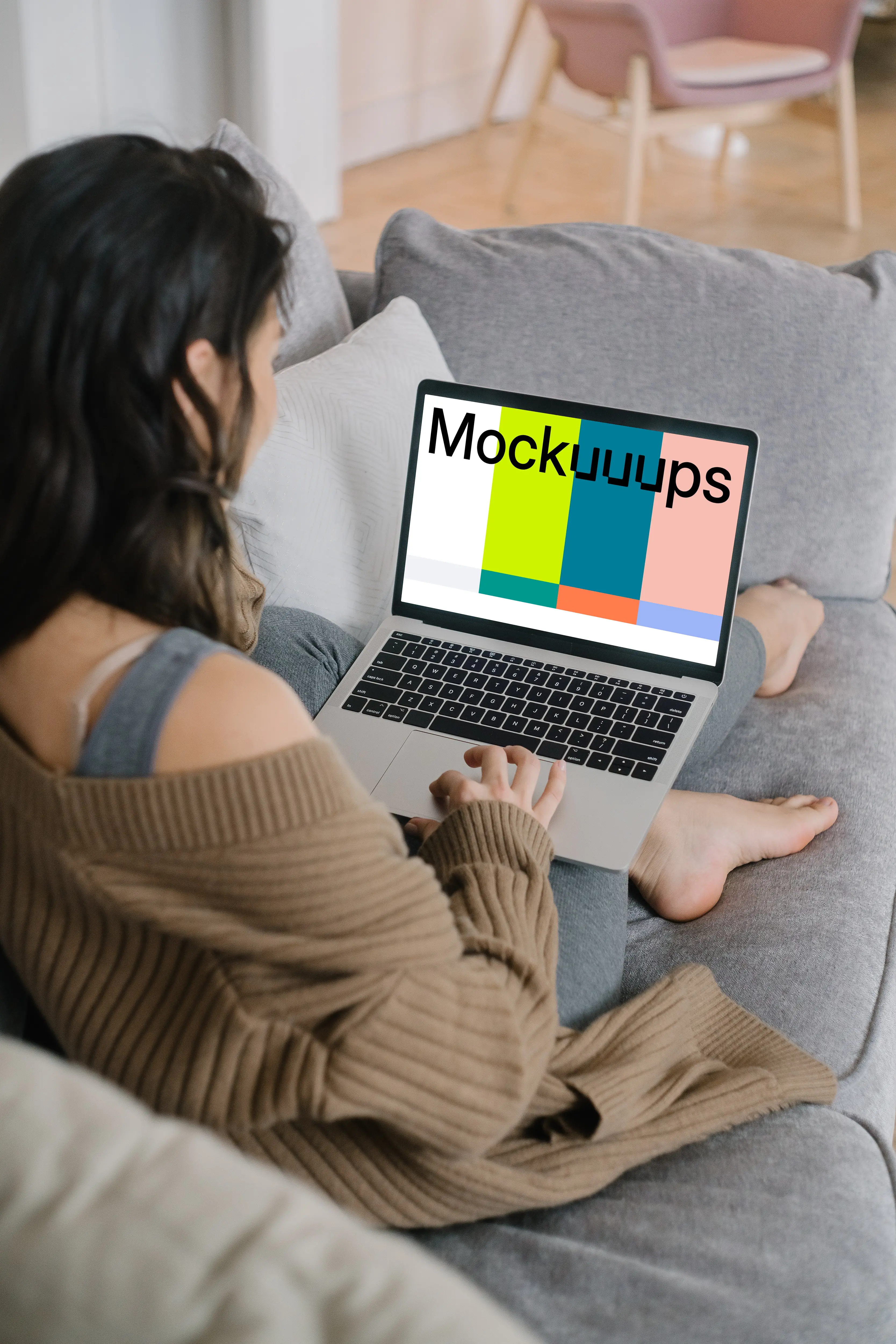 MacBook Pro mockup on a lady’s lap laying on a couch